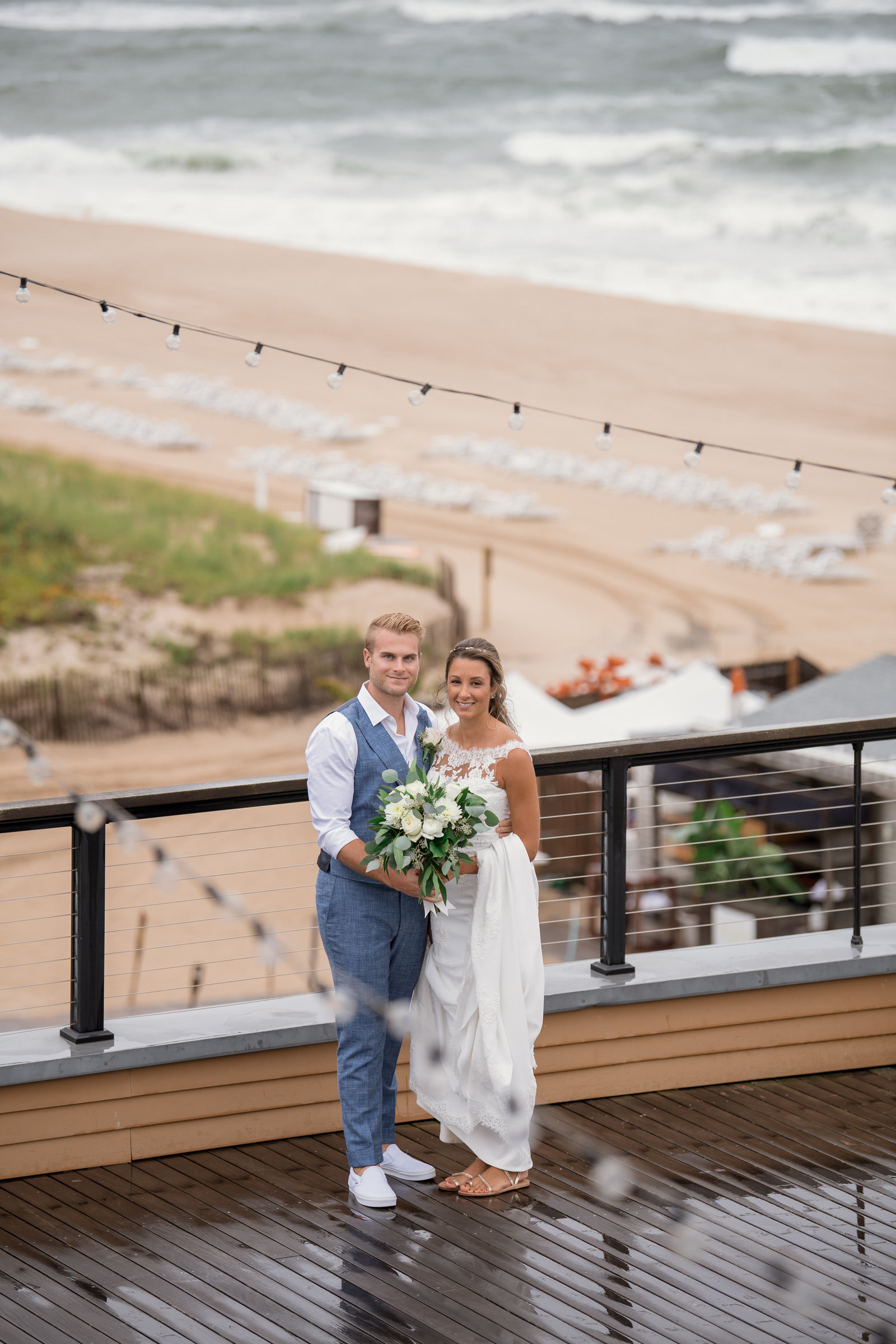 photo of bride and groom smiling on the outside deck at Gurneys Montauk Resort wedding