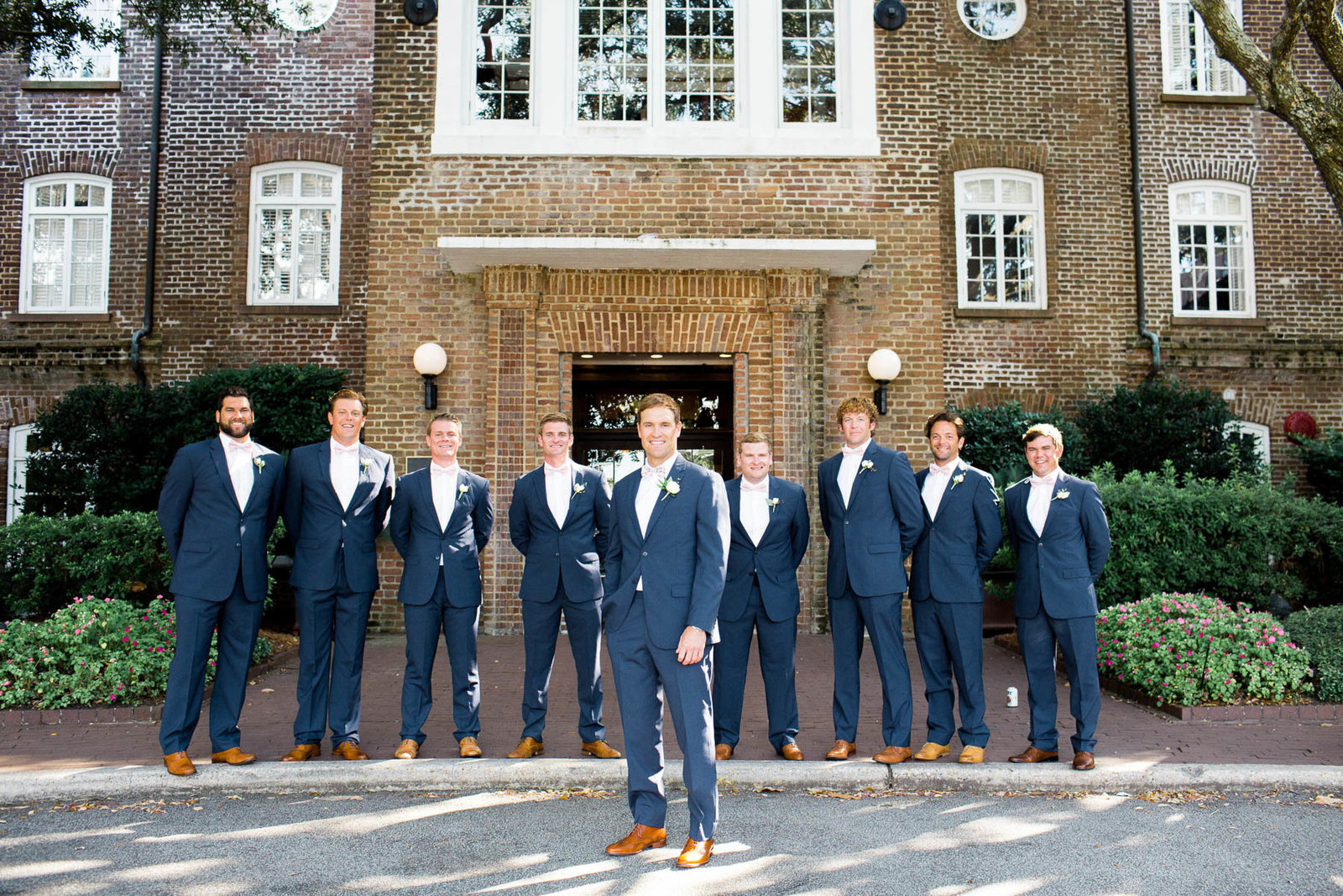 Groomsmen line up in front of the Rice Mill Building, Charleston, South Carolina