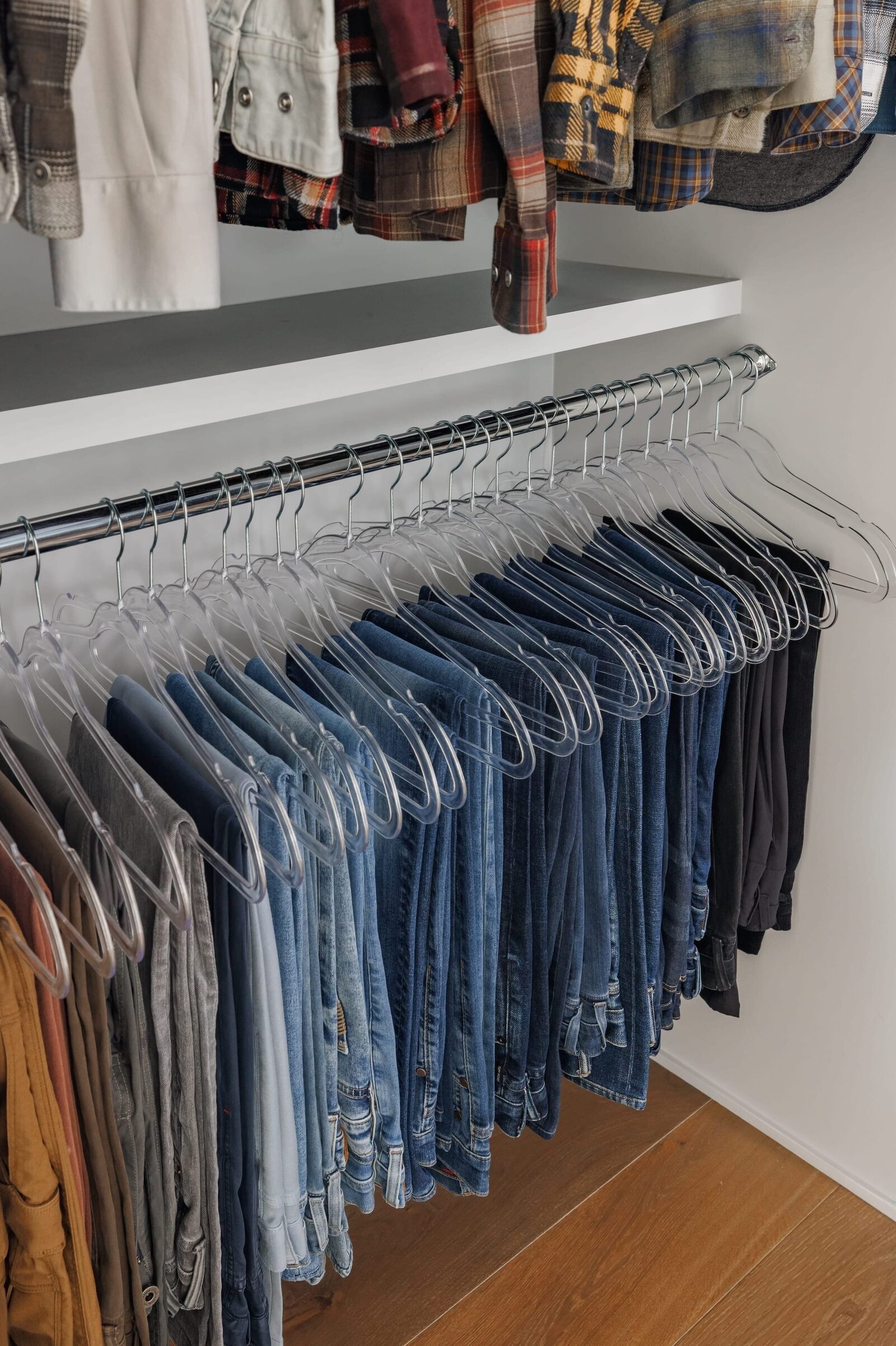 vision and hammer organizing mens closet with jeans on hangers