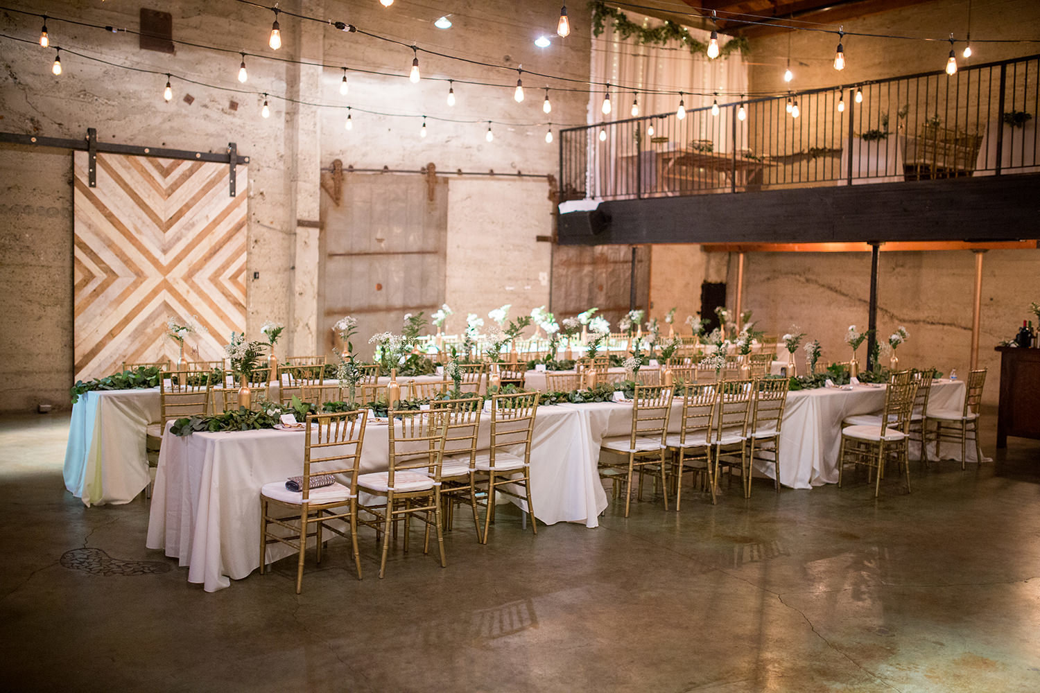 reception space at luce loft with lights and flowers