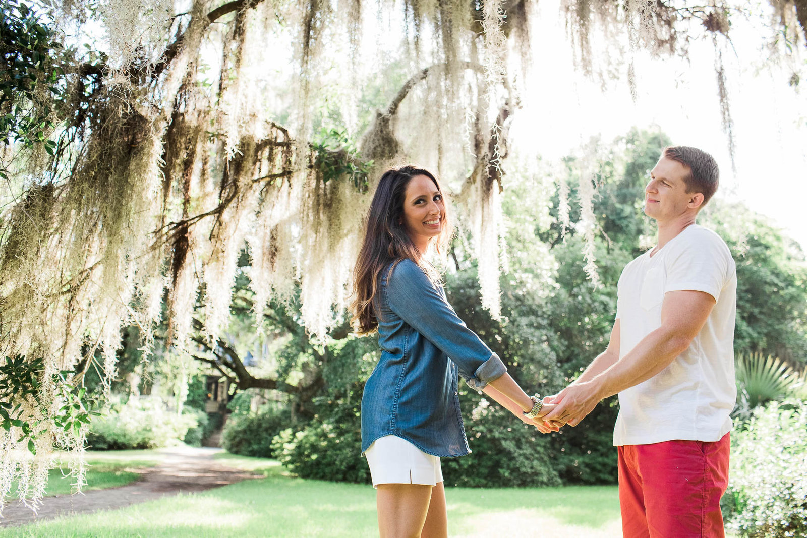 Engaged couple casually pose under spanish moss, Magnolia Plantation, Charleston, South Carolina