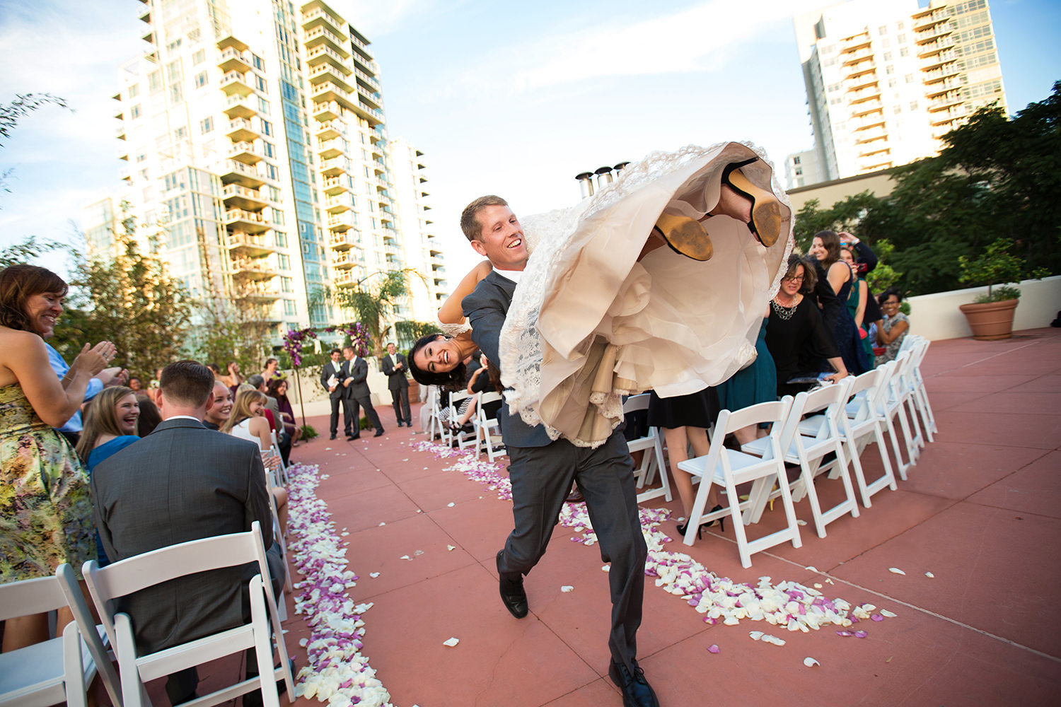 groom carries bride down the aisle funny