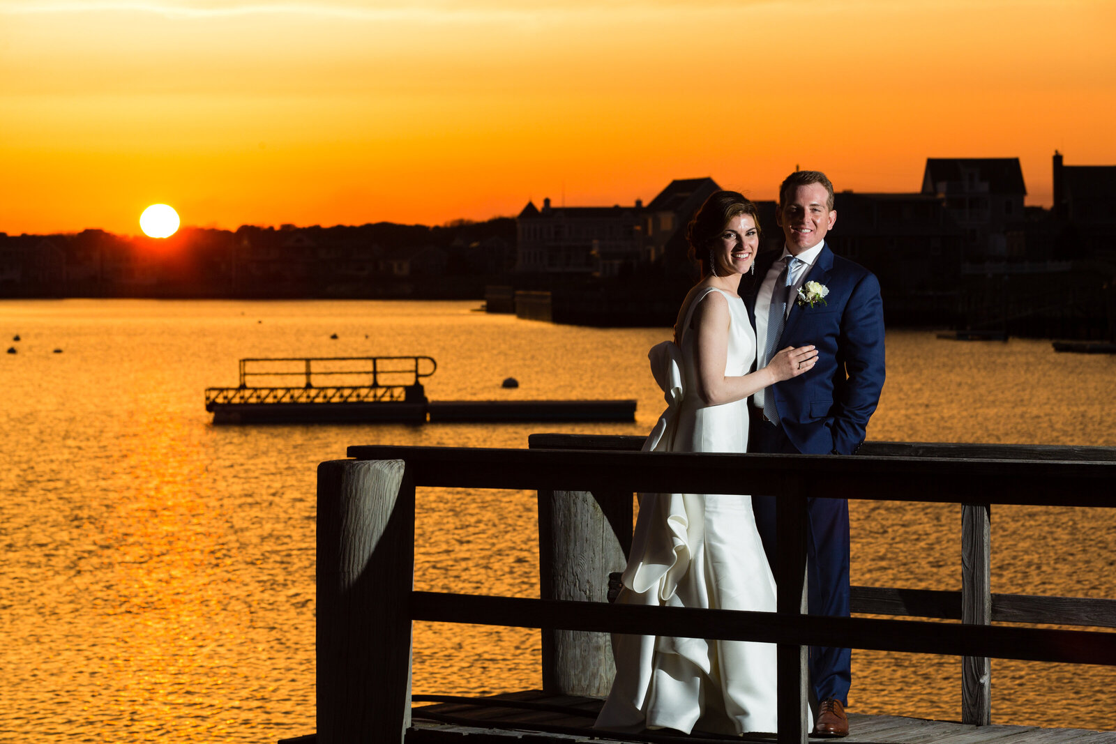 portrait of couple on dock at sunset