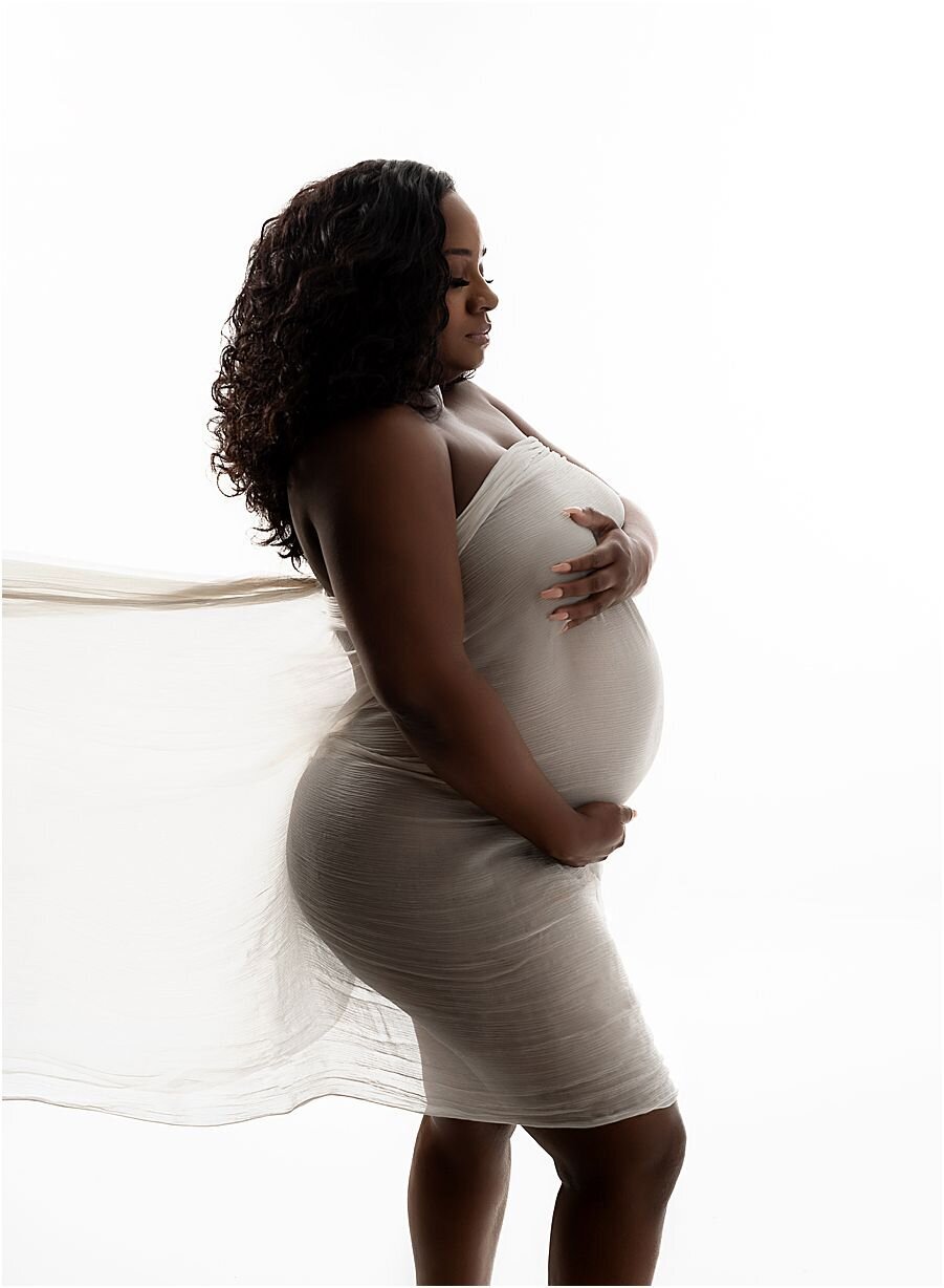 maternity photo backlit mom wearing fabric