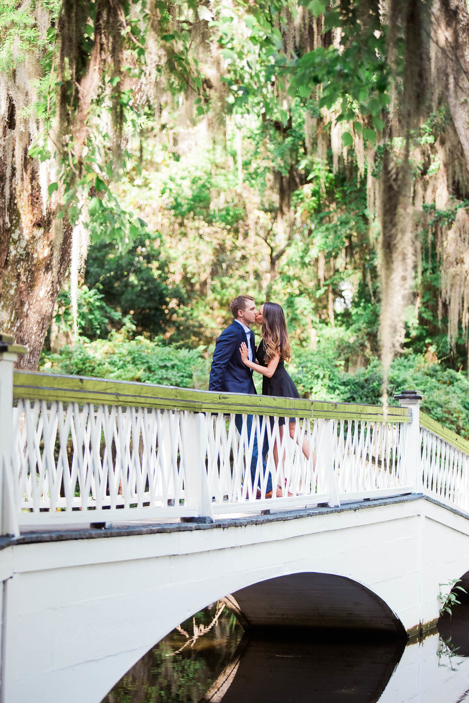 Engaged couple stand on a white bridge, Magnolia Plantation, Charleston, South Carolina