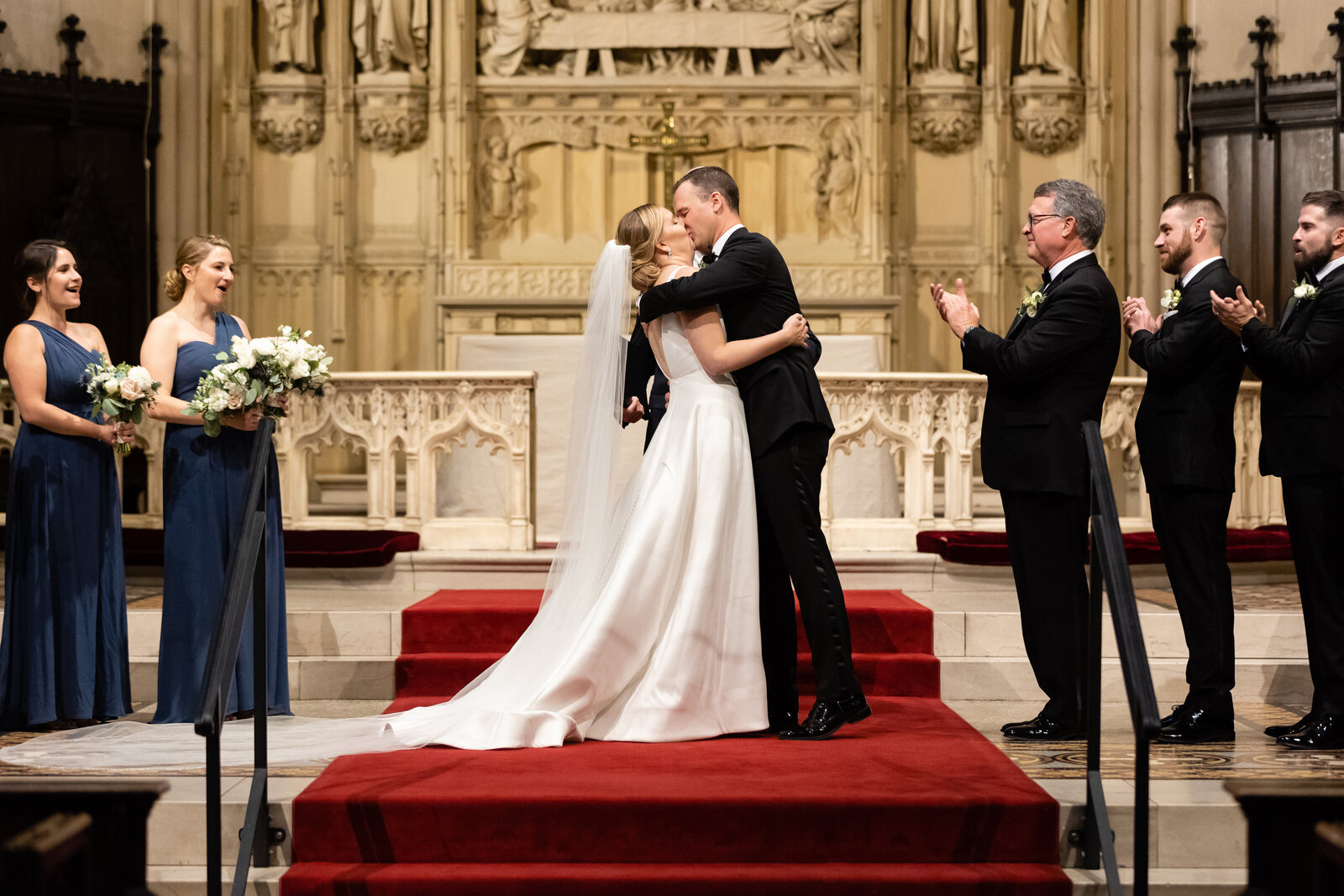 couple kisses on the altar at boston wedding ceremony