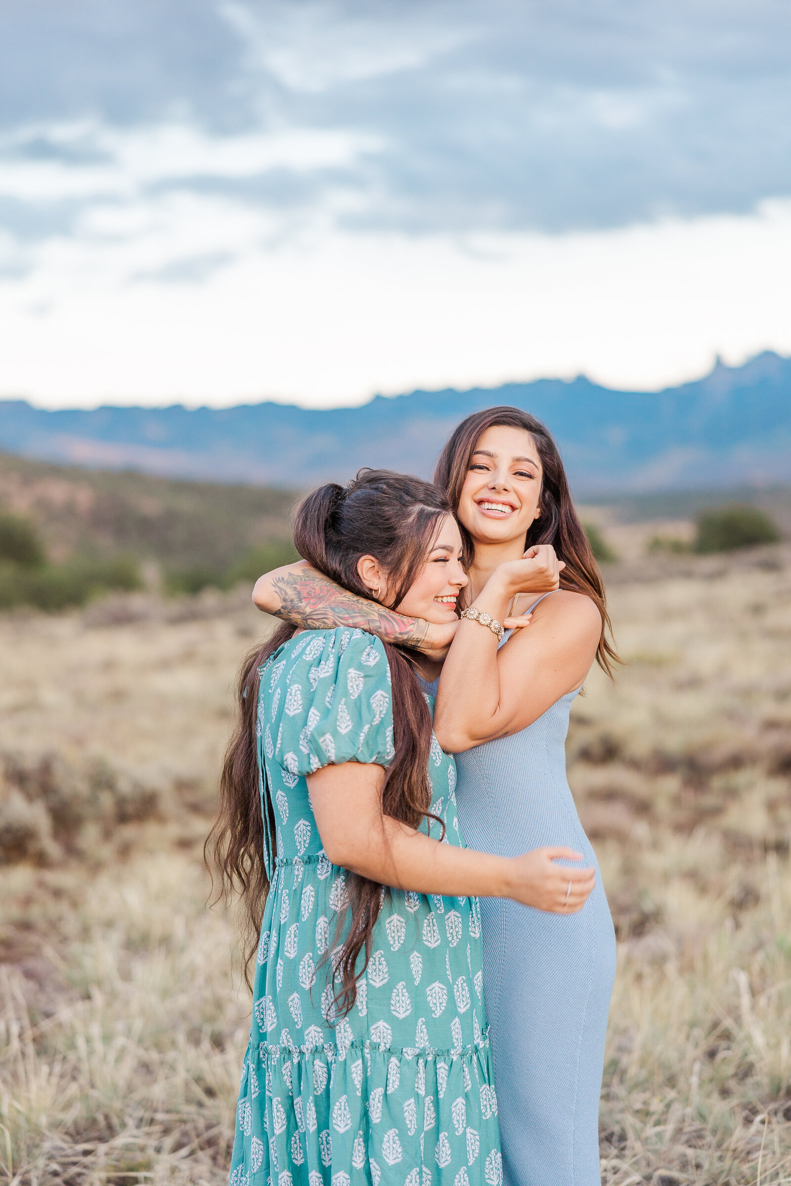 sister puts younger sister in a headlock as a joke for photo