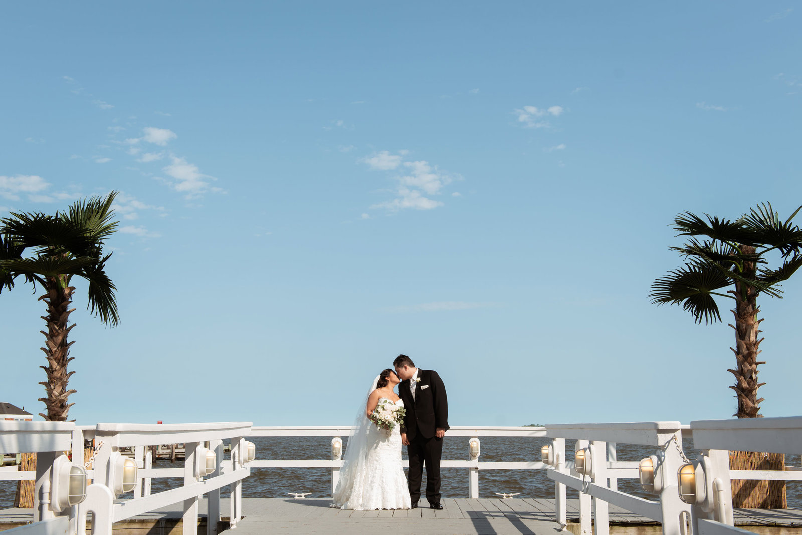 Bride and groom on dock at Chateau La Mer