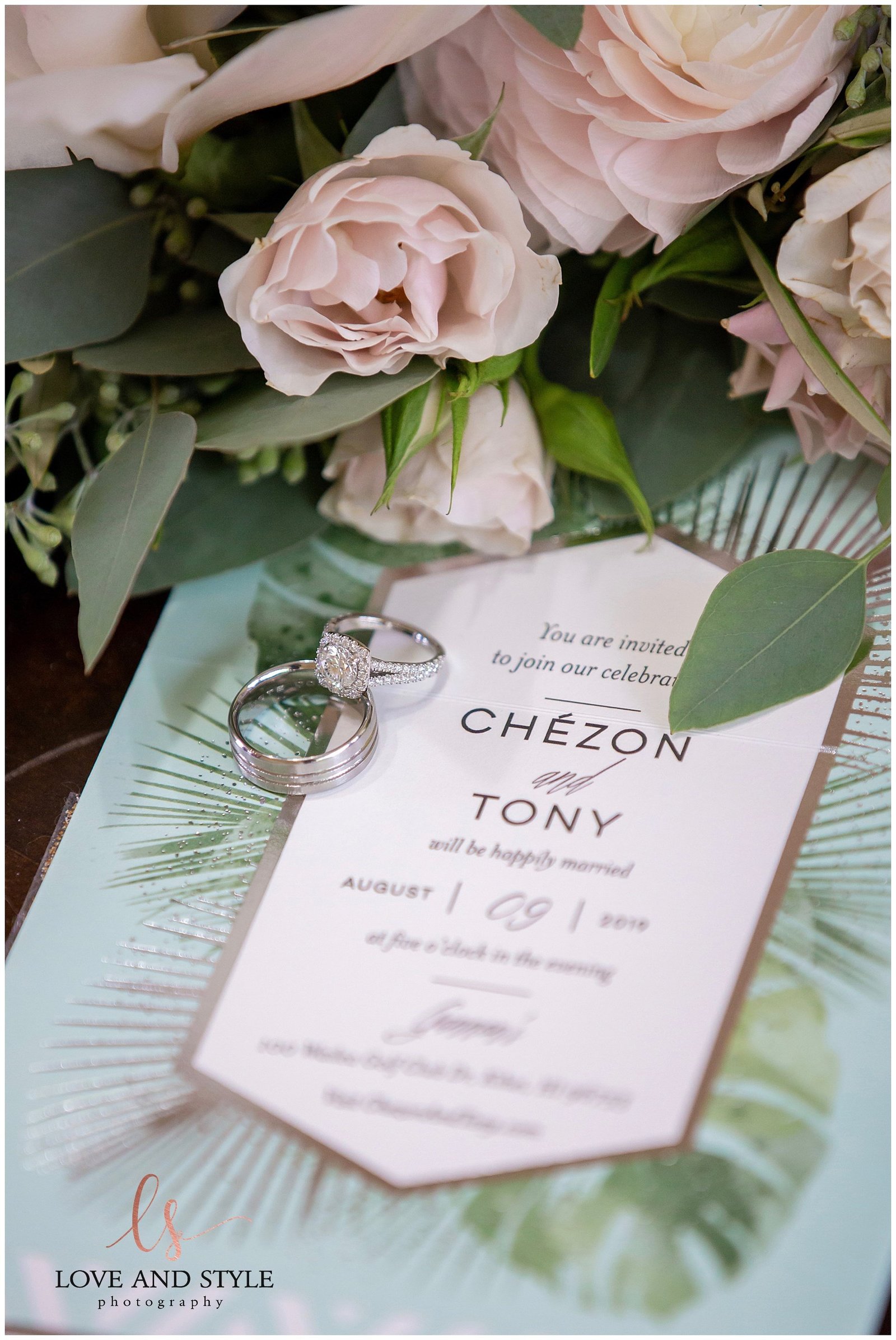 detail shot of a wedding invitation with the wedding rings