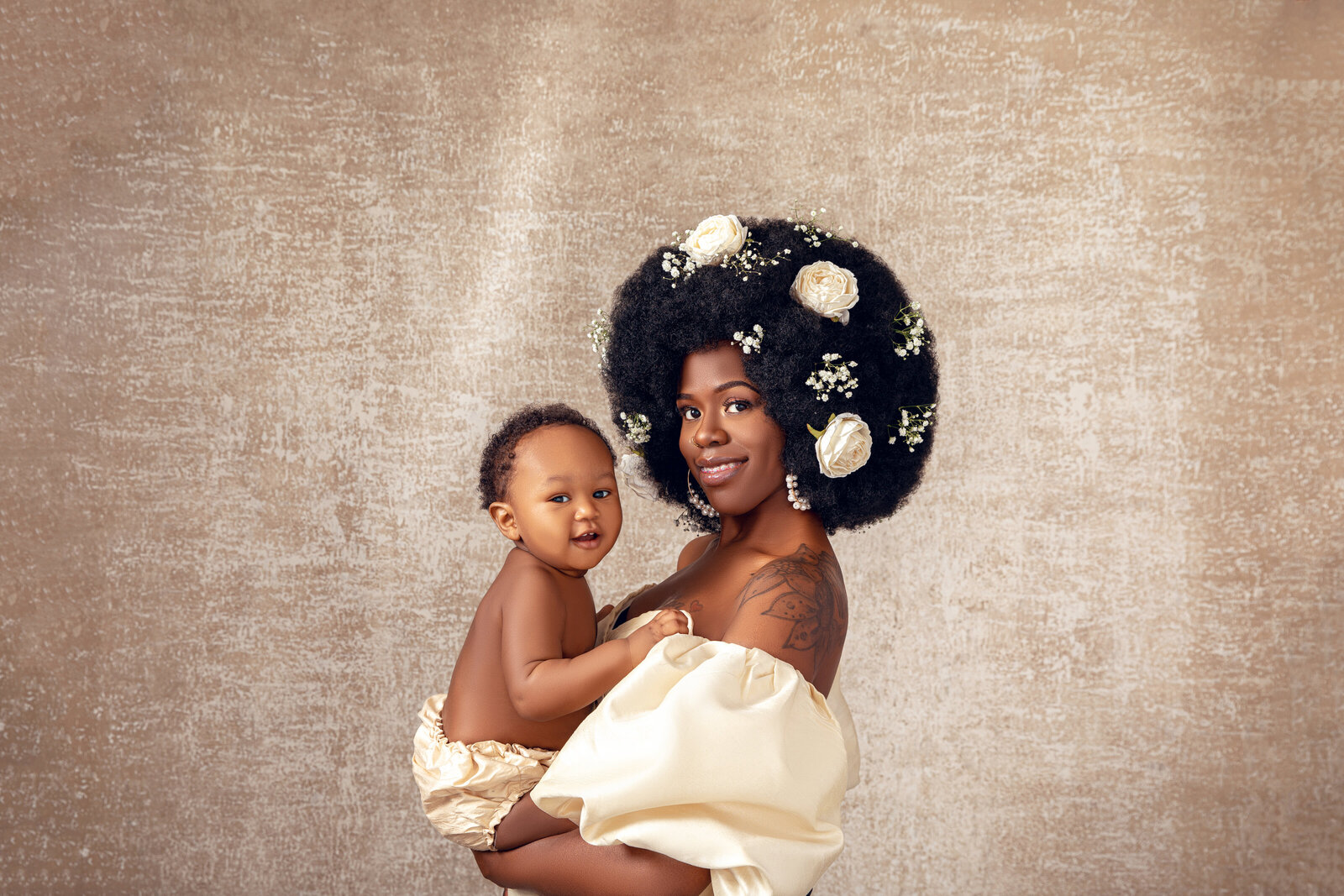 motherhood photoshoot with baby and florals