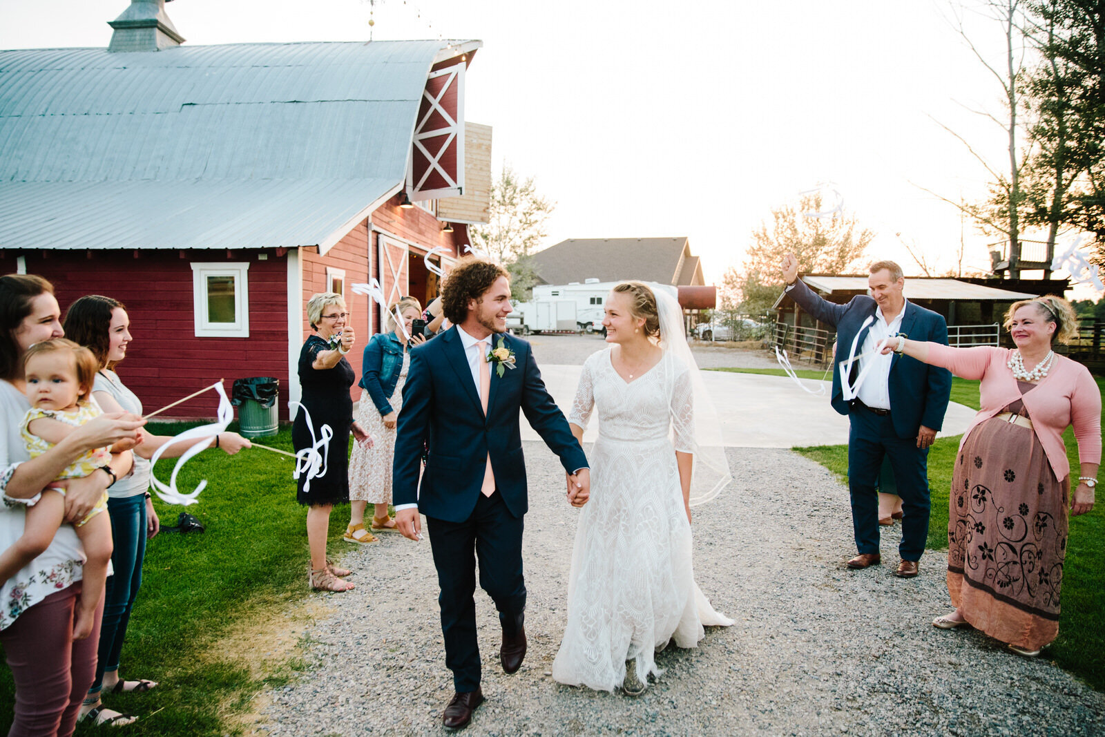 bride and groom walking out of jackson hole wedding reception together
