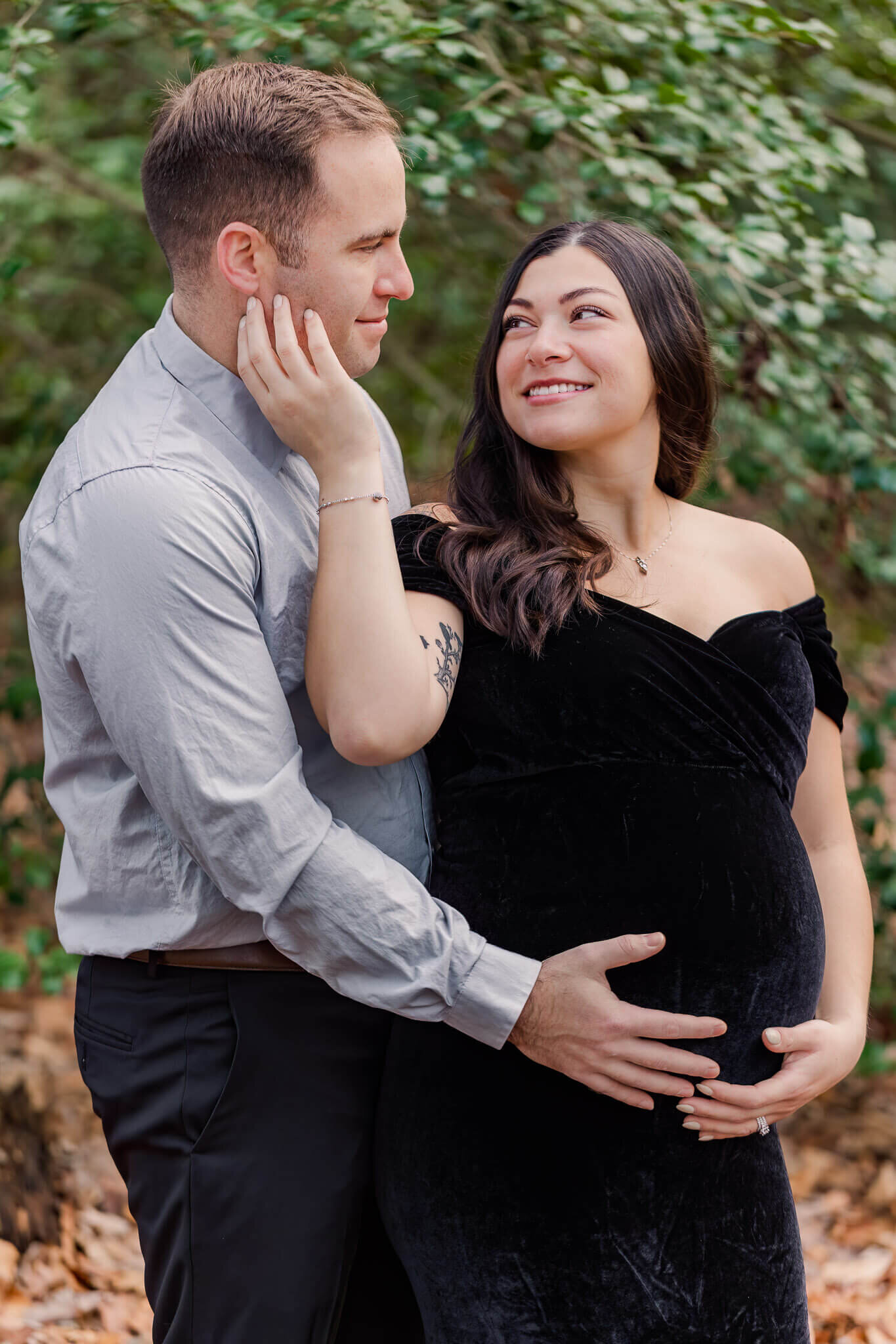 A couple embracing in a Burke, Virginia park during their maternity session.