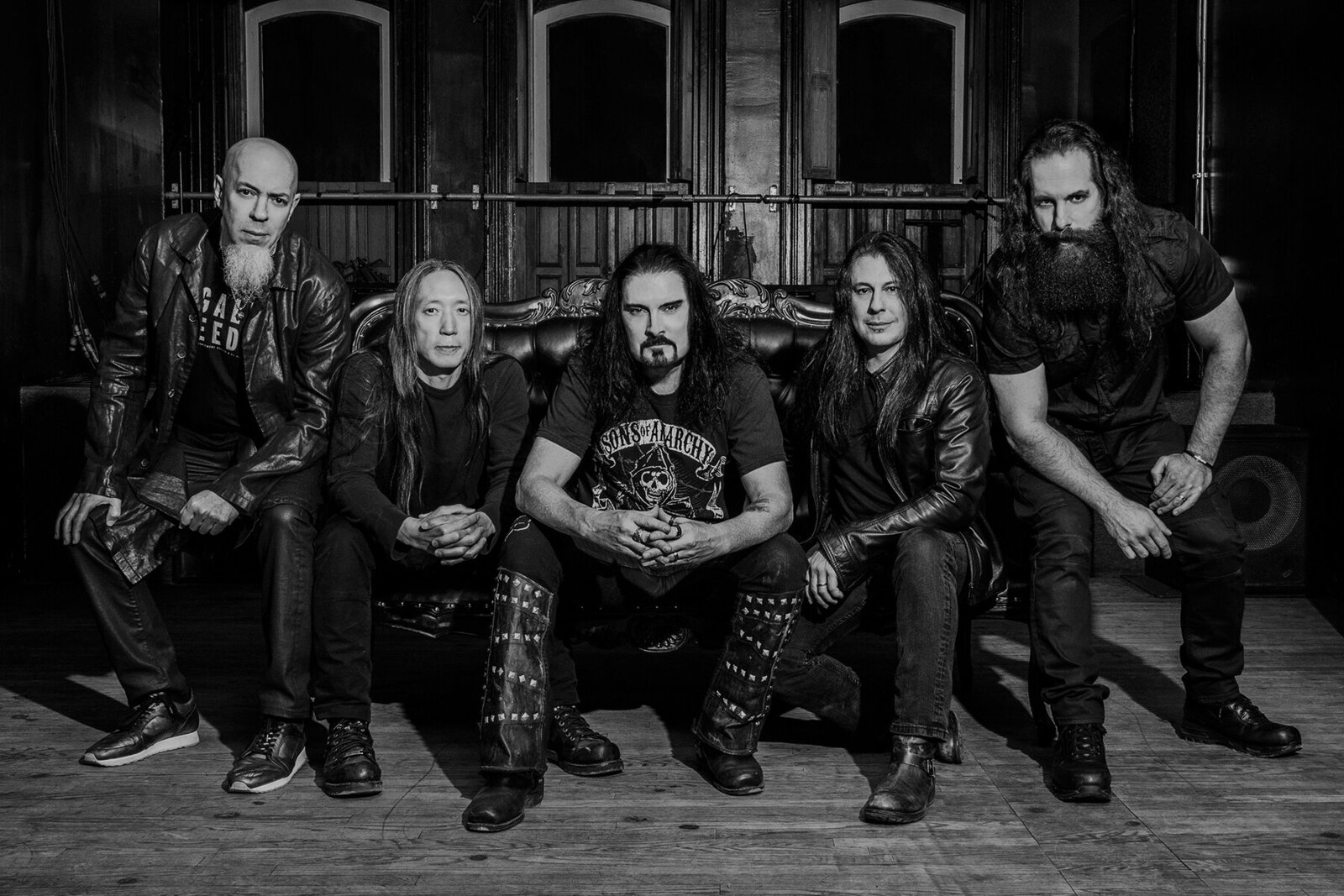 Music group portrait Dream Theater black and white sitting on sofa