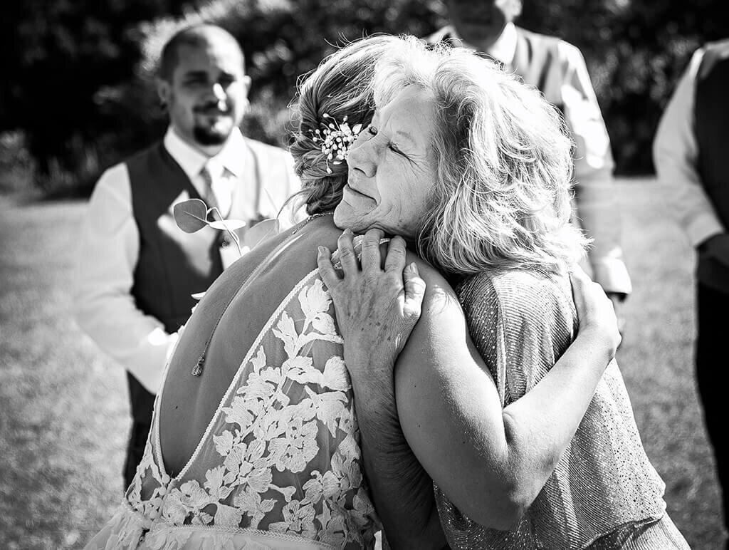 Mother and Bride Hugging During Wedding Ceremony