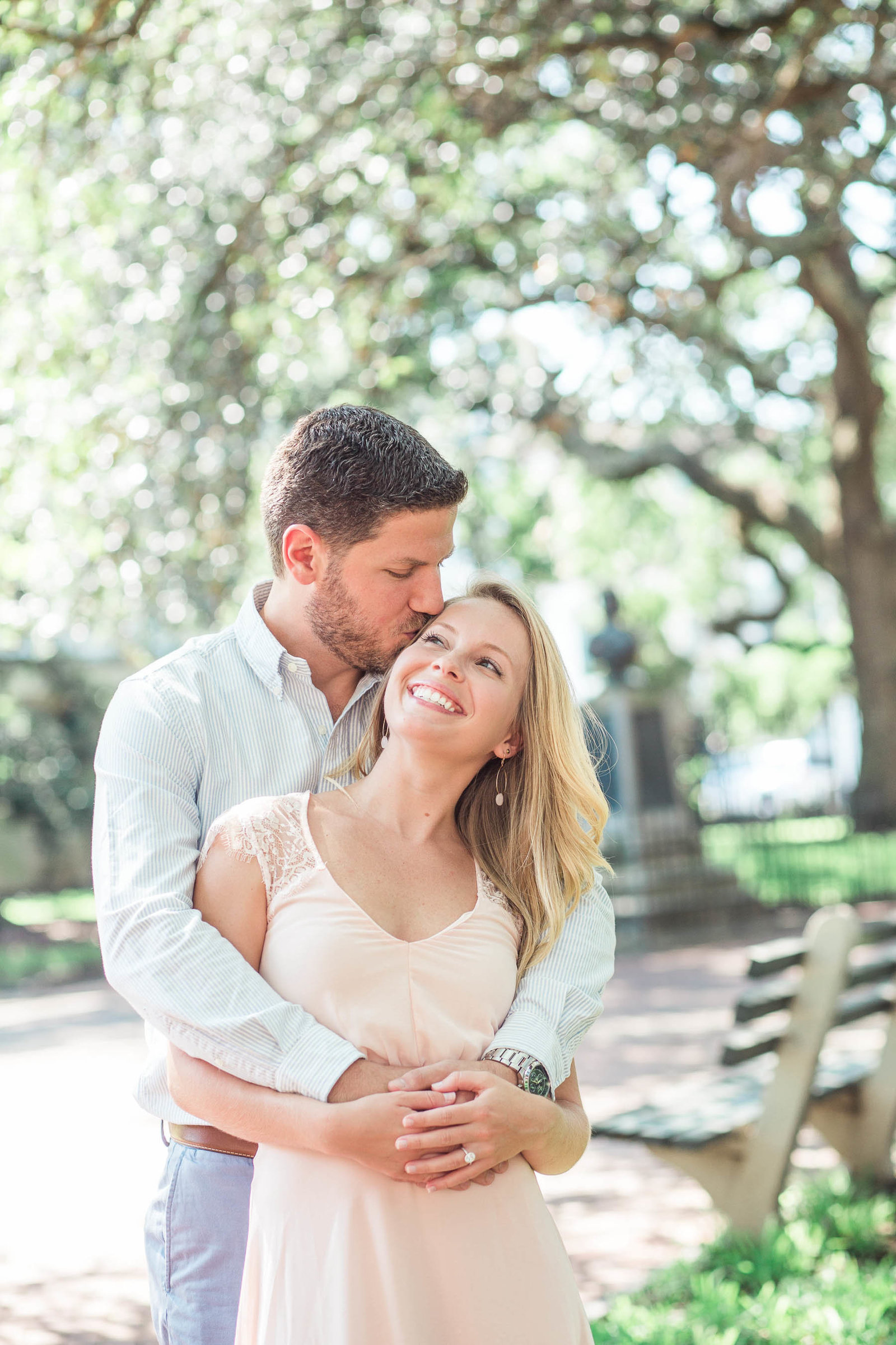 Engaged couple snuggles under oak trees, Downtown Charleston, South Carolina