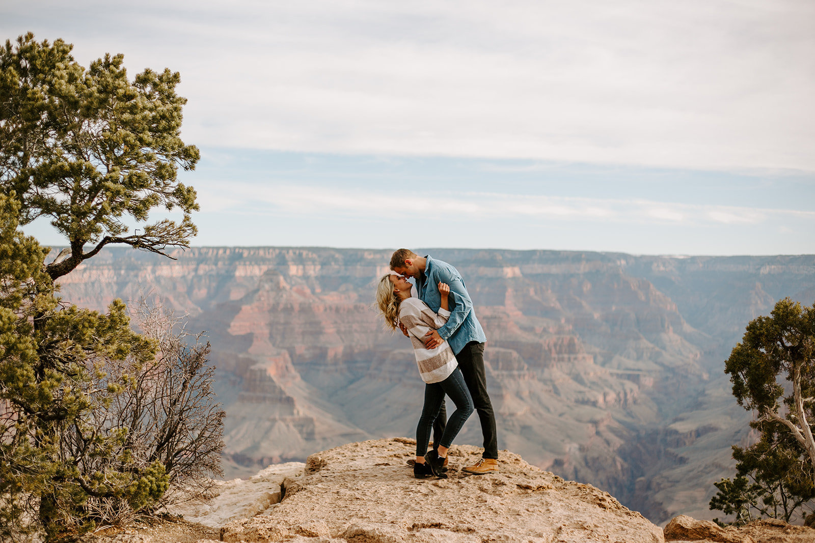 Couple kissing on the edge of the Grand Canyon during their Arizona Engagement Session