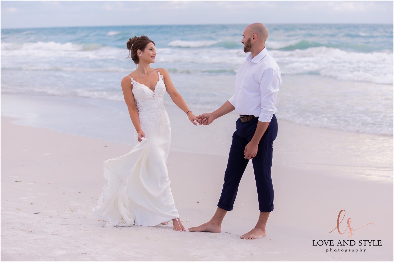Bride and Groom walking on Bradenton Beach in front of The Beach House Restaurant