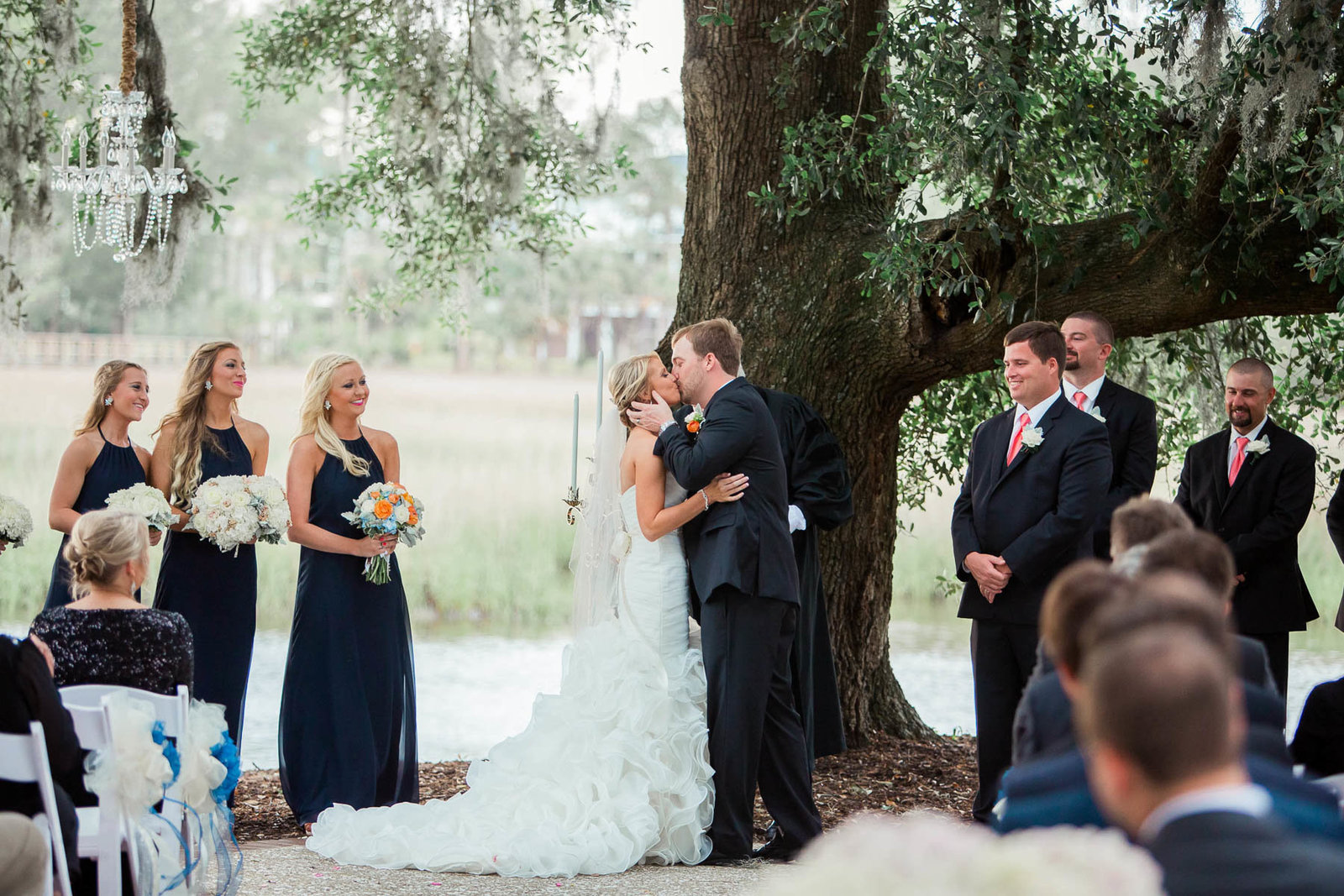 Bride and groom kiss under an oak tree, Dunes West Golf and River Club, Mt Pleasant, South Carolina