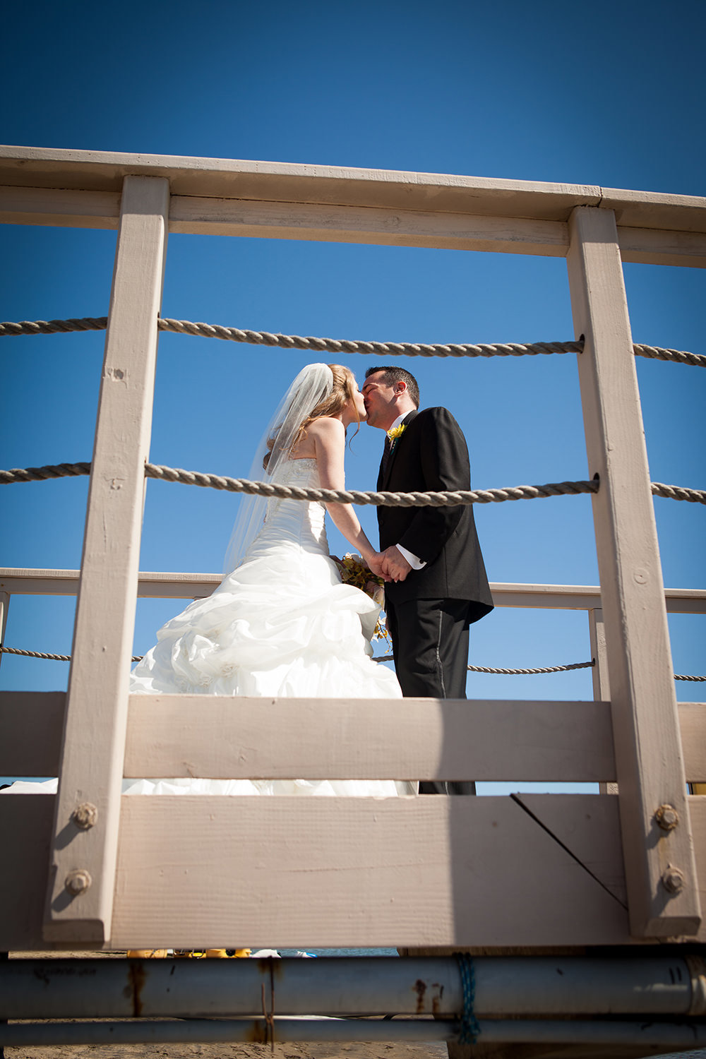 bride and groom on dock at hilton mission bay