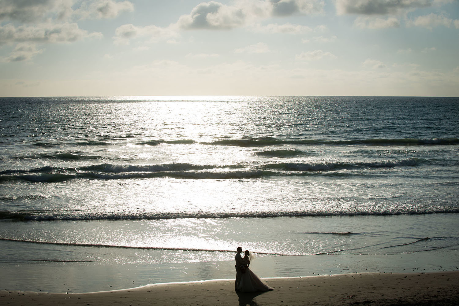 Creative silhouette of the bride and groom on the beach in Del Mar