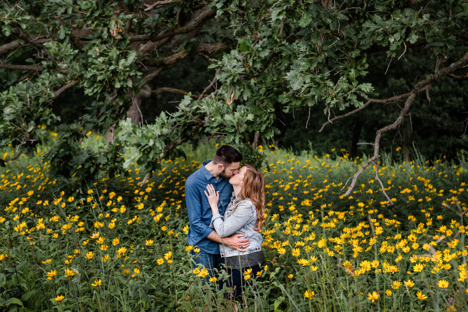 Couple standing in field with flowers