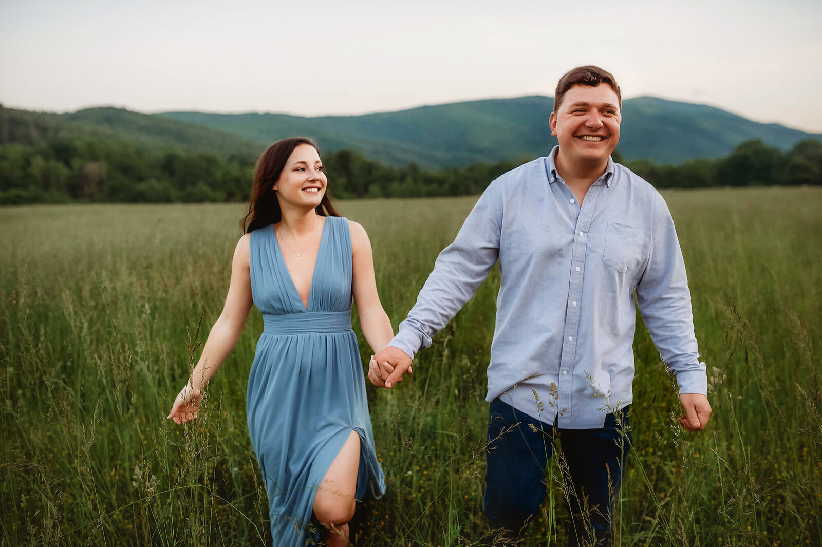 Couple walks hand in hand during Engagement Photos in Asheville, NC.