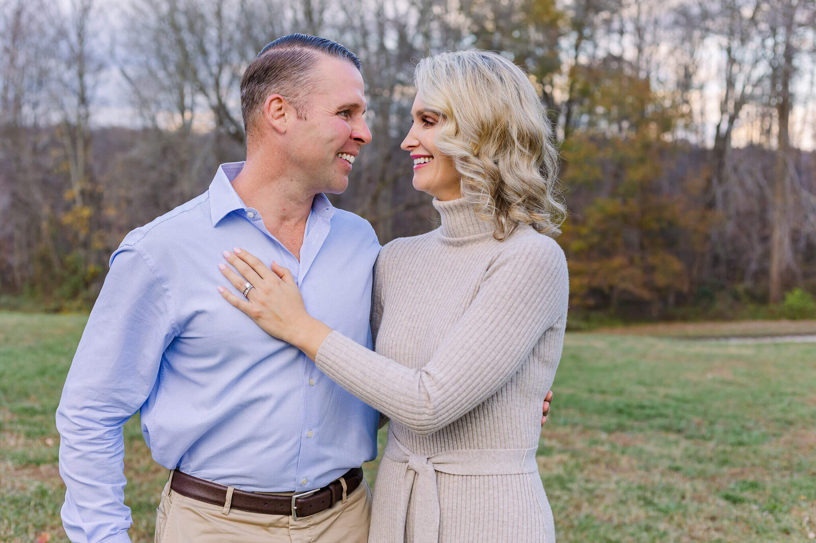 A mom and dad looking lovingly at each other during a family photo session in Northern Virginia.