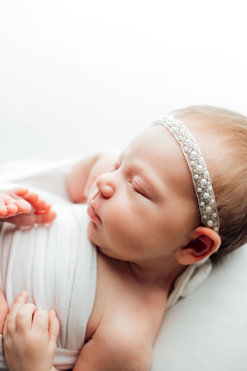 Newborn baby side profile sleeping by best newborn photographers nj
