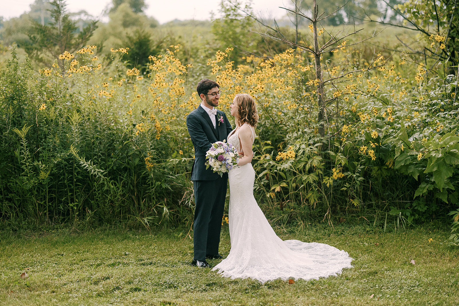 bride and groom smiling at each other at barnwood events, a wedding a venue in madison, winconsin.