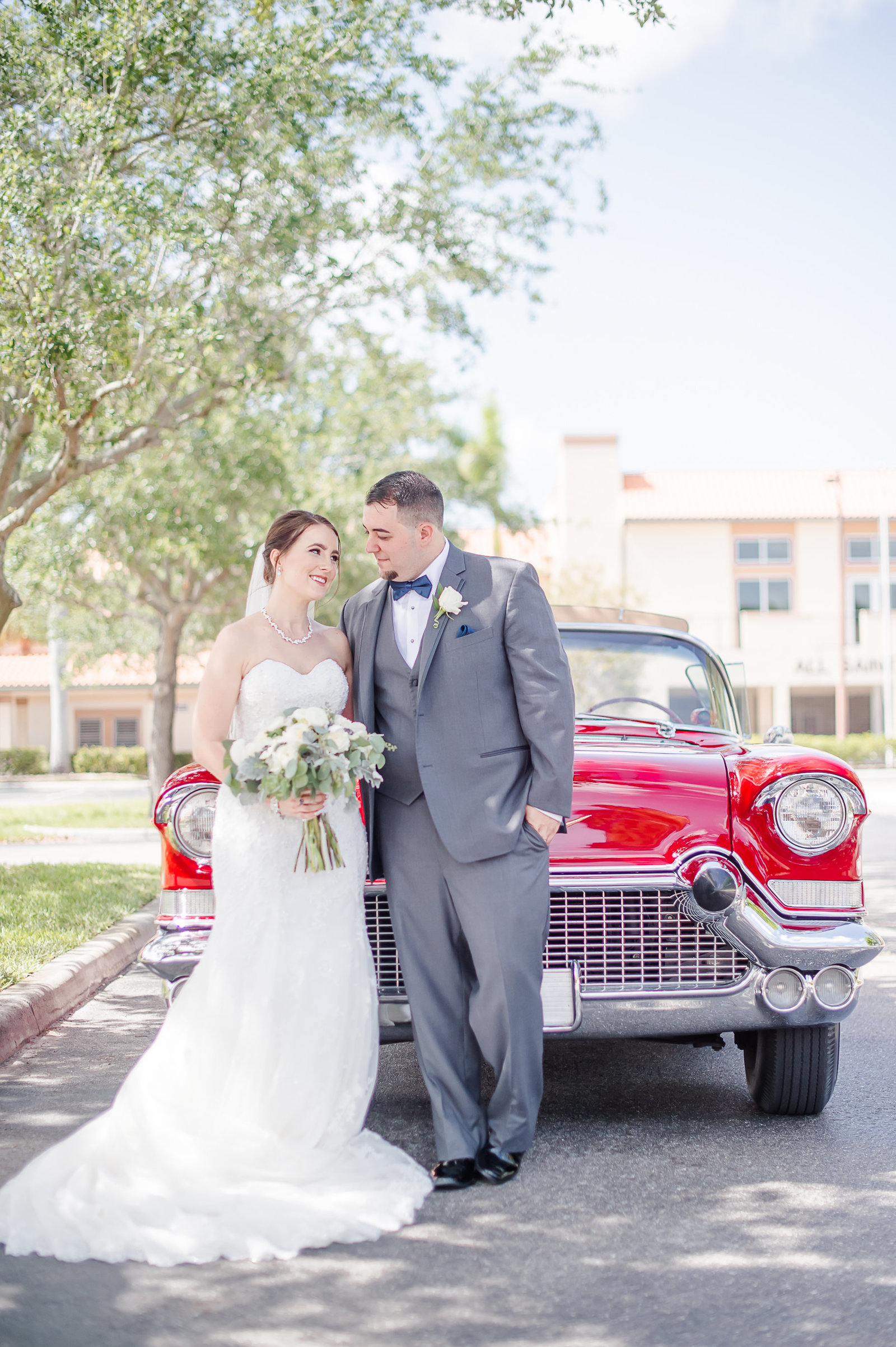 Newlywed in red classic car - Country Club at Mirasol Wedding - Palm Beach Wedding Photography by Palm Beach Photography, Inc.