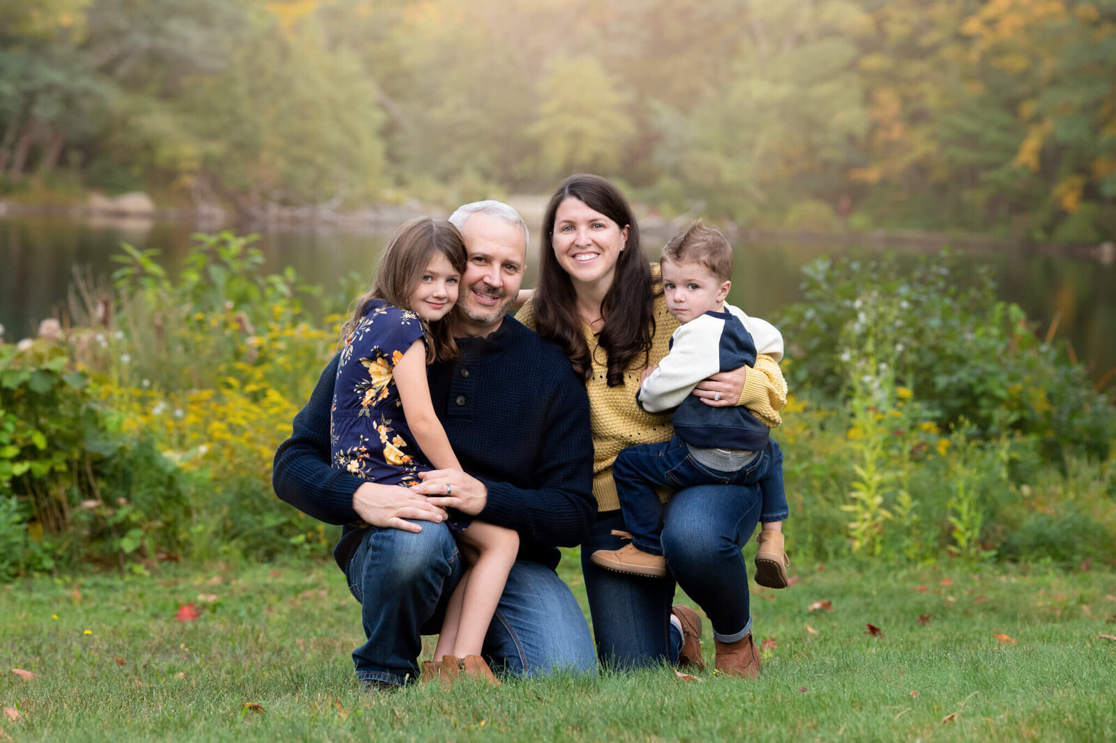 Family photo of a mother, father, and two children in fall