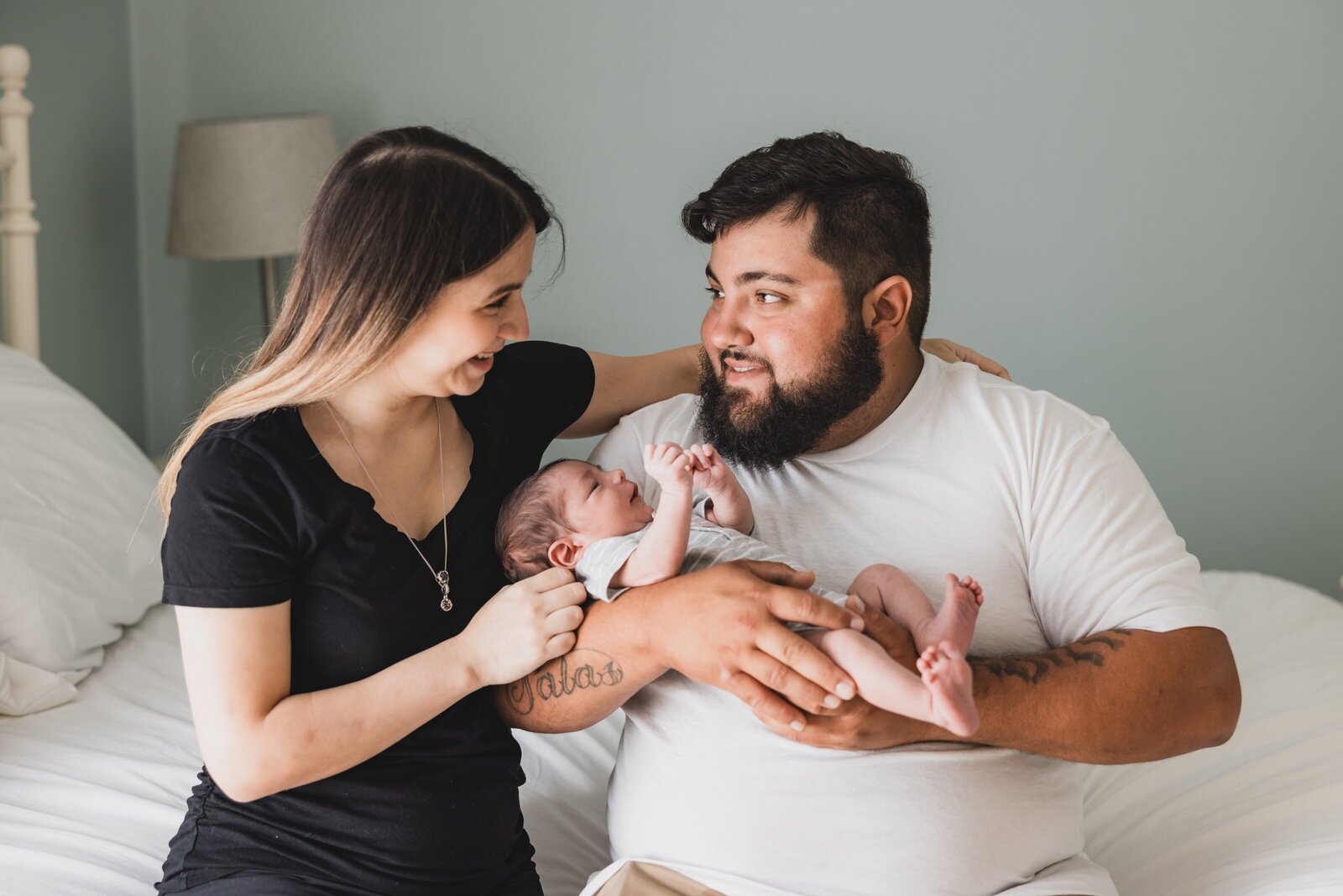 New parents holding newborn during lifestyle newborn  session