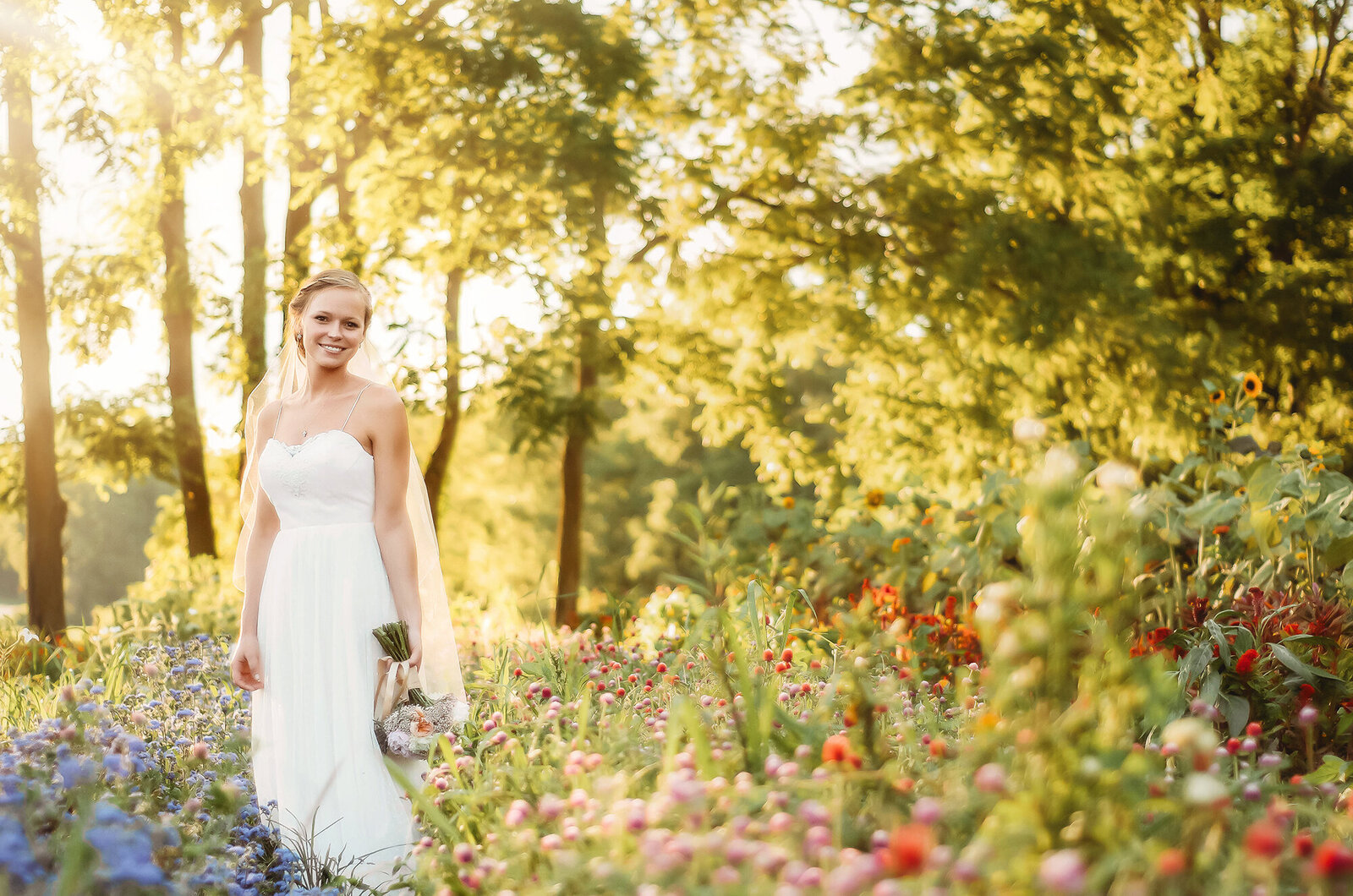 Bride poses for Bridal Portraits in a field of flowers in Asheville, NC.