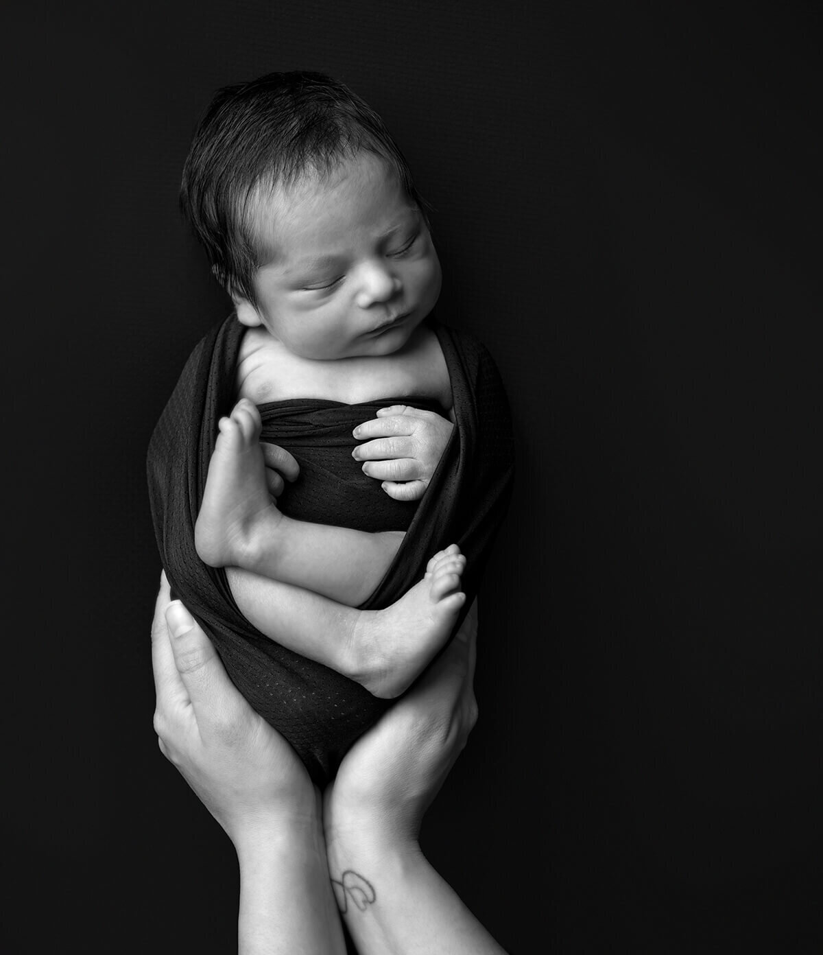 newborn baby in black and white