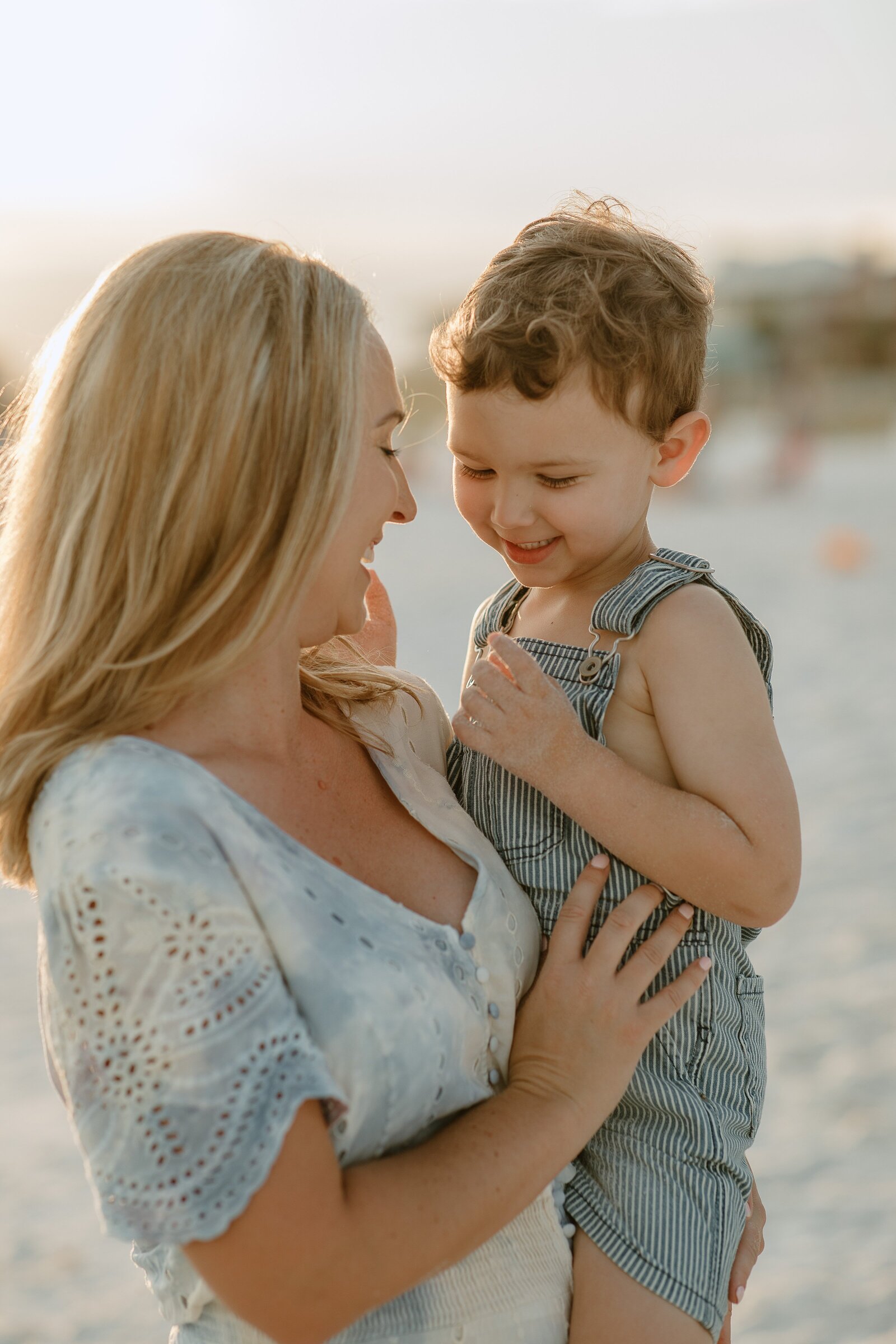 Pensacola Beach vacation family photography session .  Mother and son on  the beach at sunset.