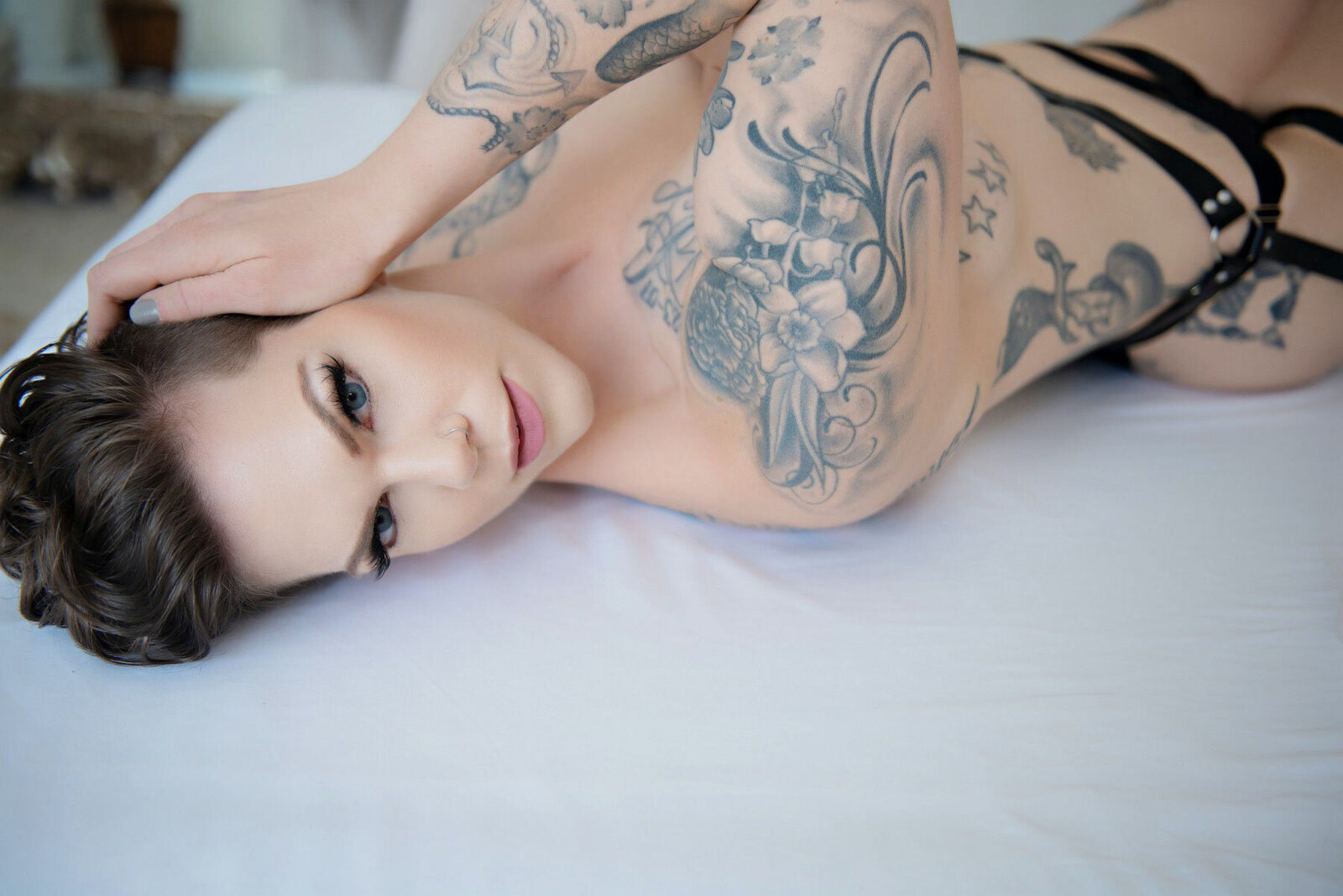 Boudoir portrait of androgynous  tattoedwoman