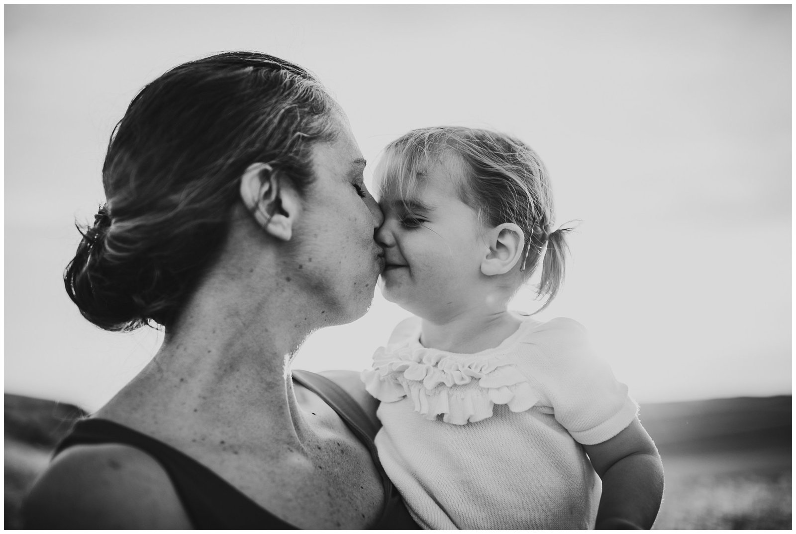 little girl kissing her mom black and white Emily Ann Photography Seattle Family Photographer