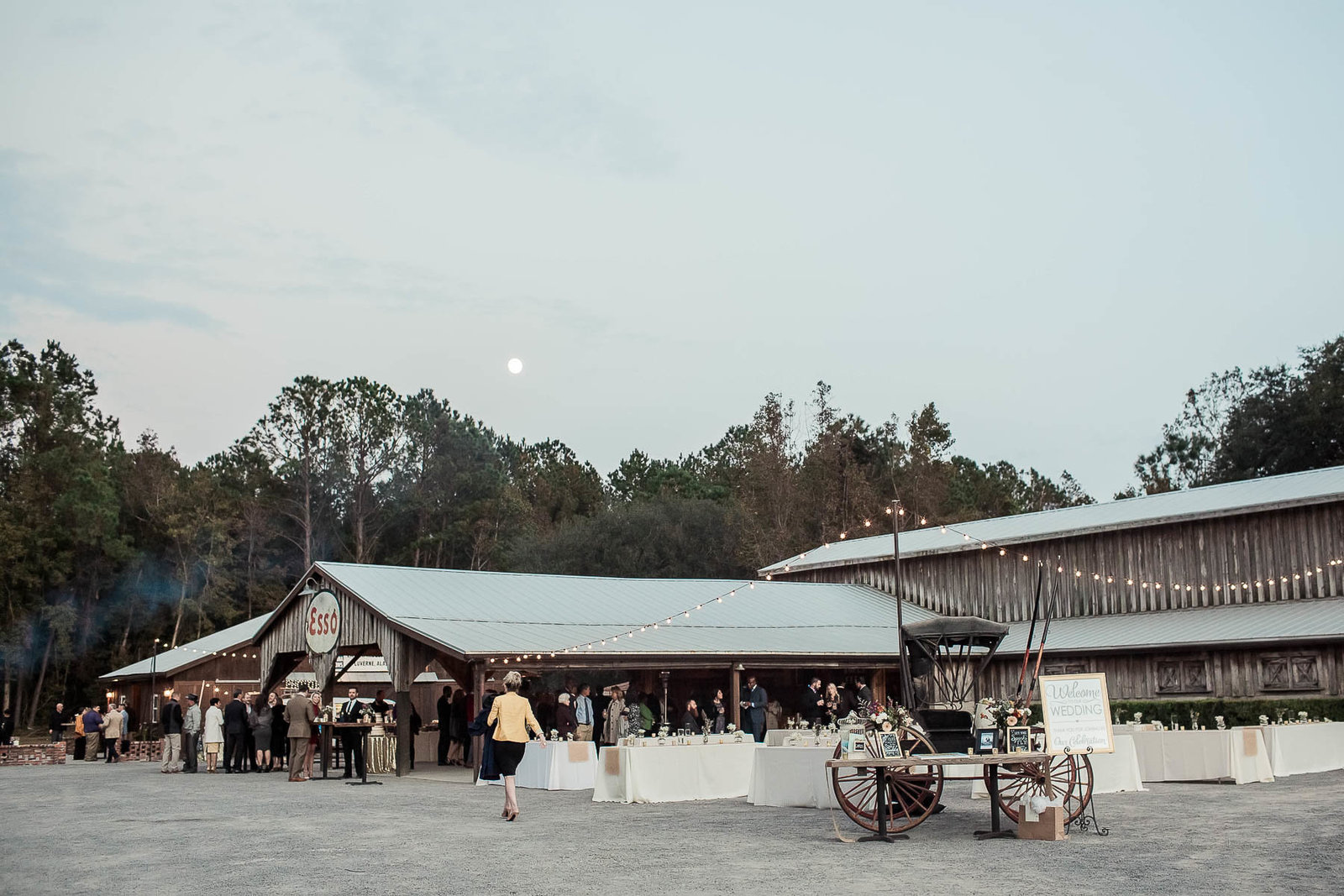 Guests mingle in rustic venue for cocktail hour, Boals Farm, Charleston, South Carolina
