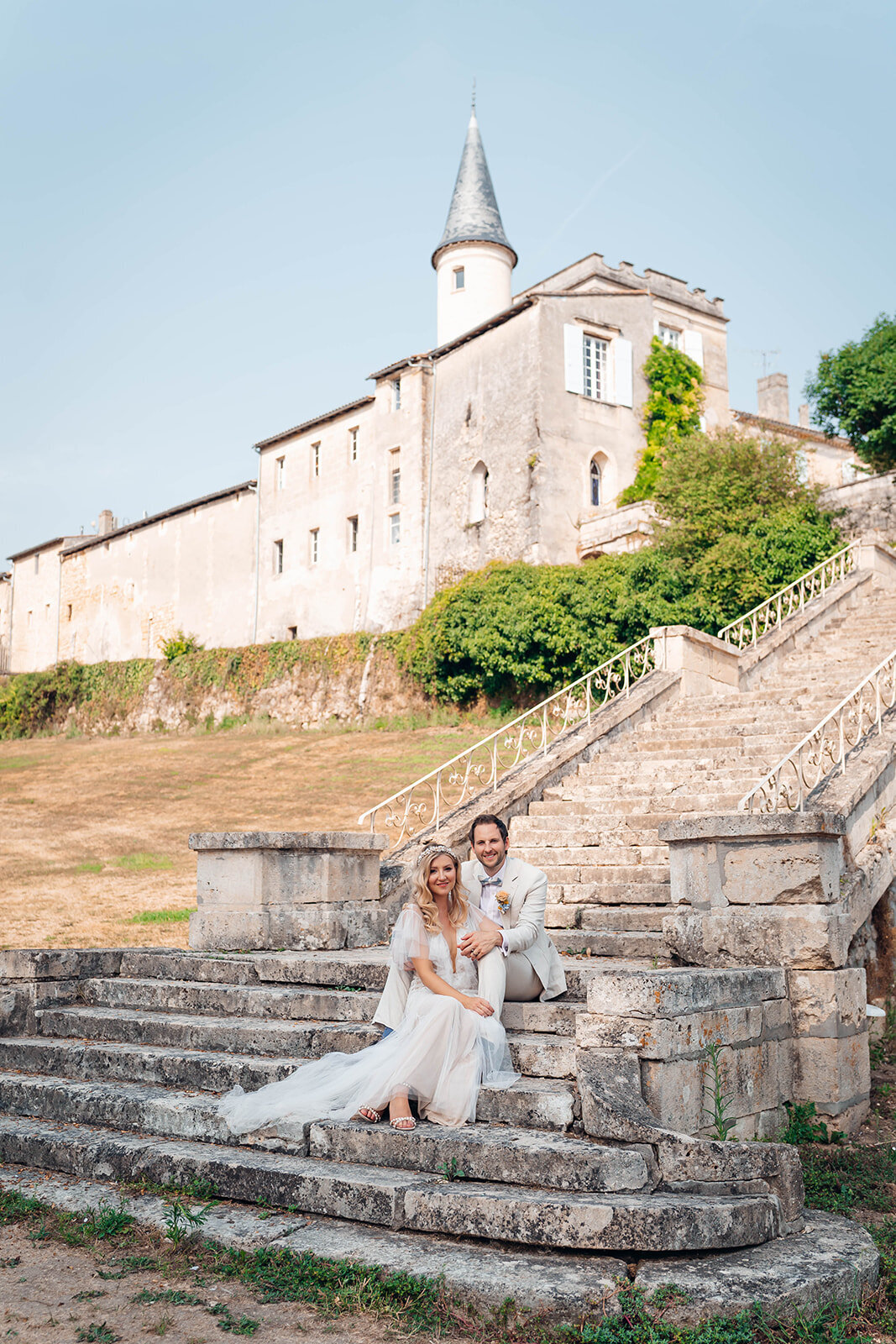 Newly-married-couple-sat-on-steps-for-couples-photographs
