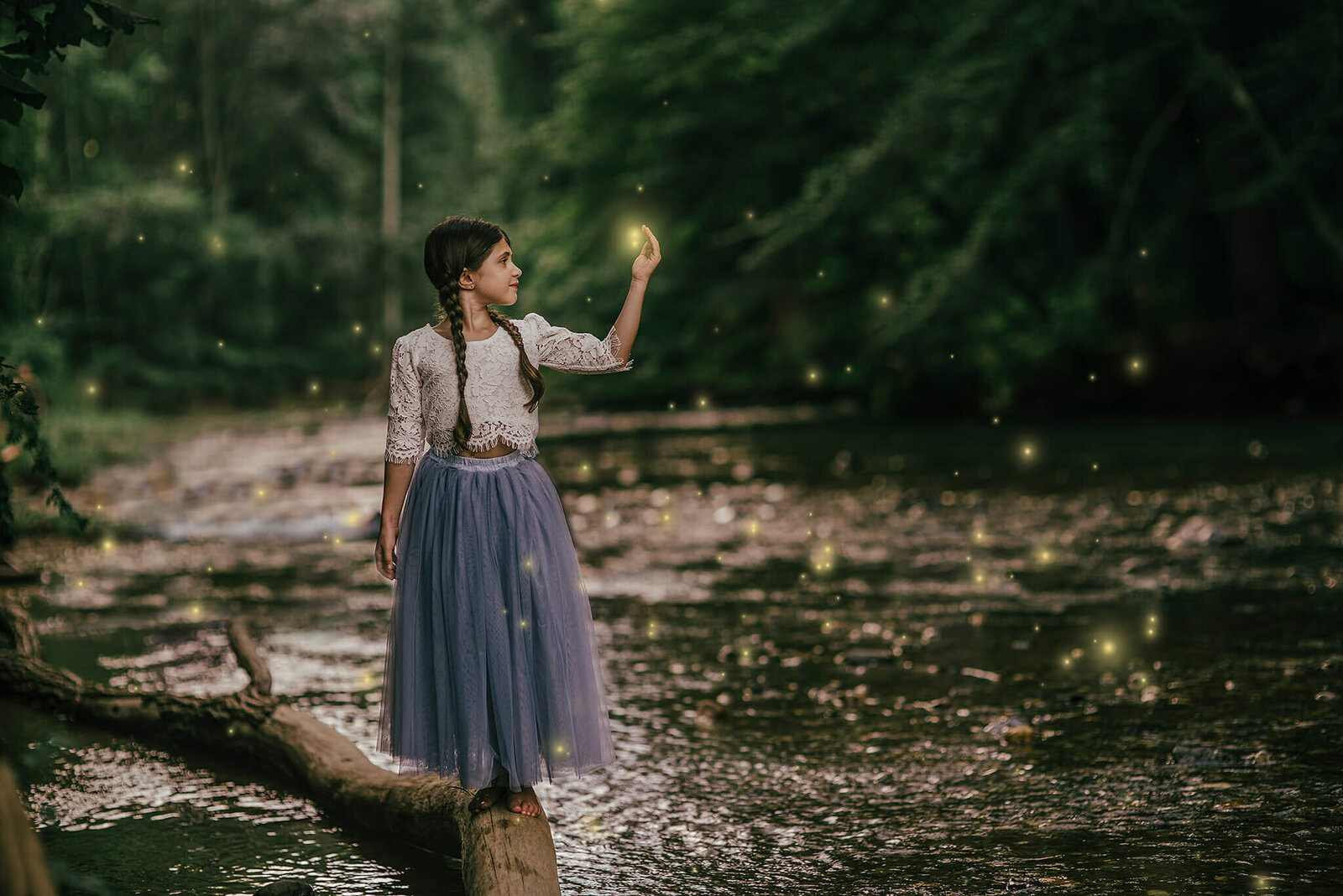 Girl standing on a log in a blue skirt at night near a creek with fireflies at Jerusalem Mill in Kingsville Maryland