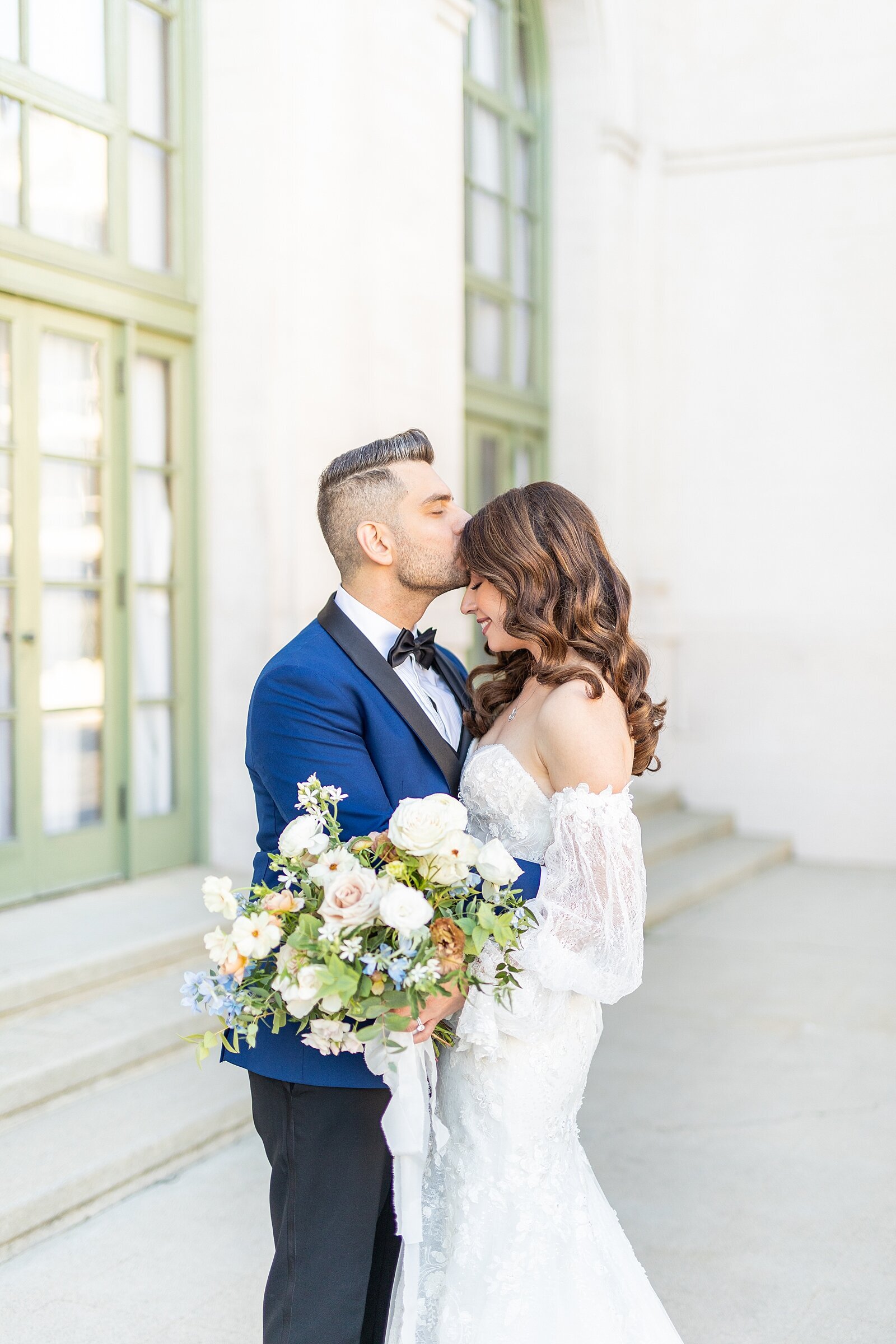Groom kissing bride's forehead at The Ebell of LA.