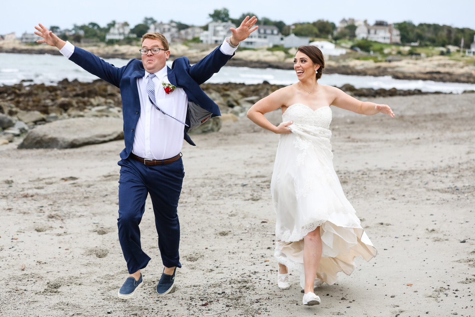 bride and groom running on beach
