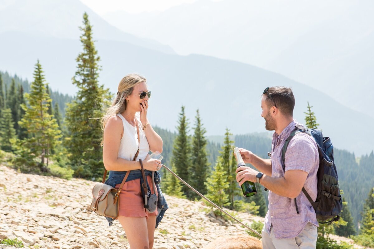 Popping champagne on top of Aspen mountain after proposing