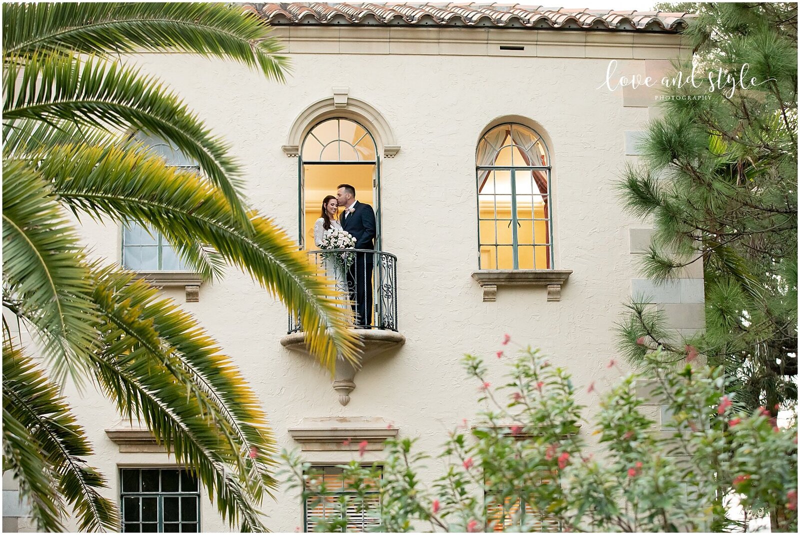 Wide angle wedding photo of Bride and groom in the window of the Powel Crosley estate.