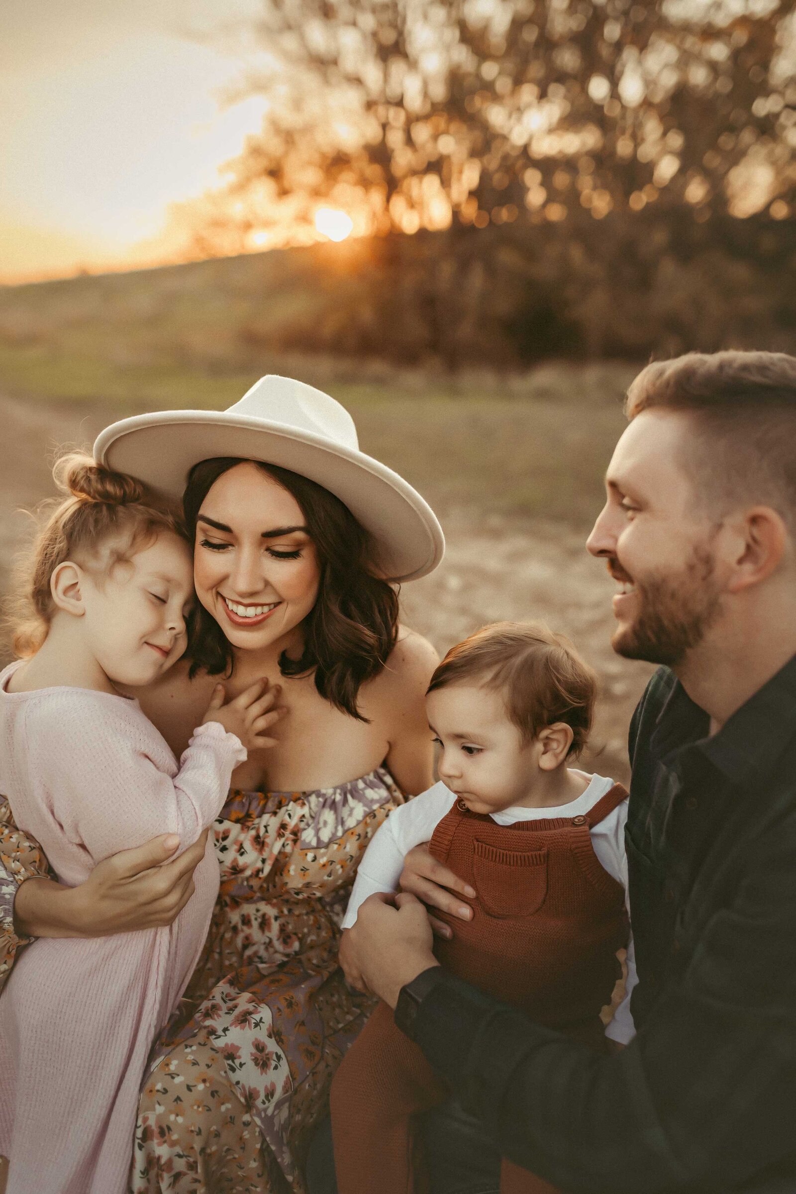 Baby girl is looking at his brother in this sweet family photo taken by Gillan Oler