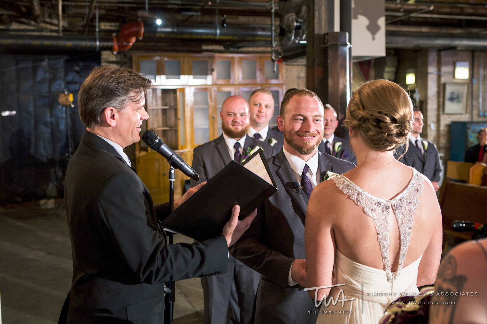 Groom smiles while taking his wedding vows