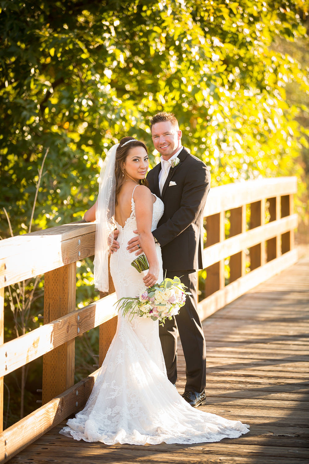 bride and groom on bridge at maderas