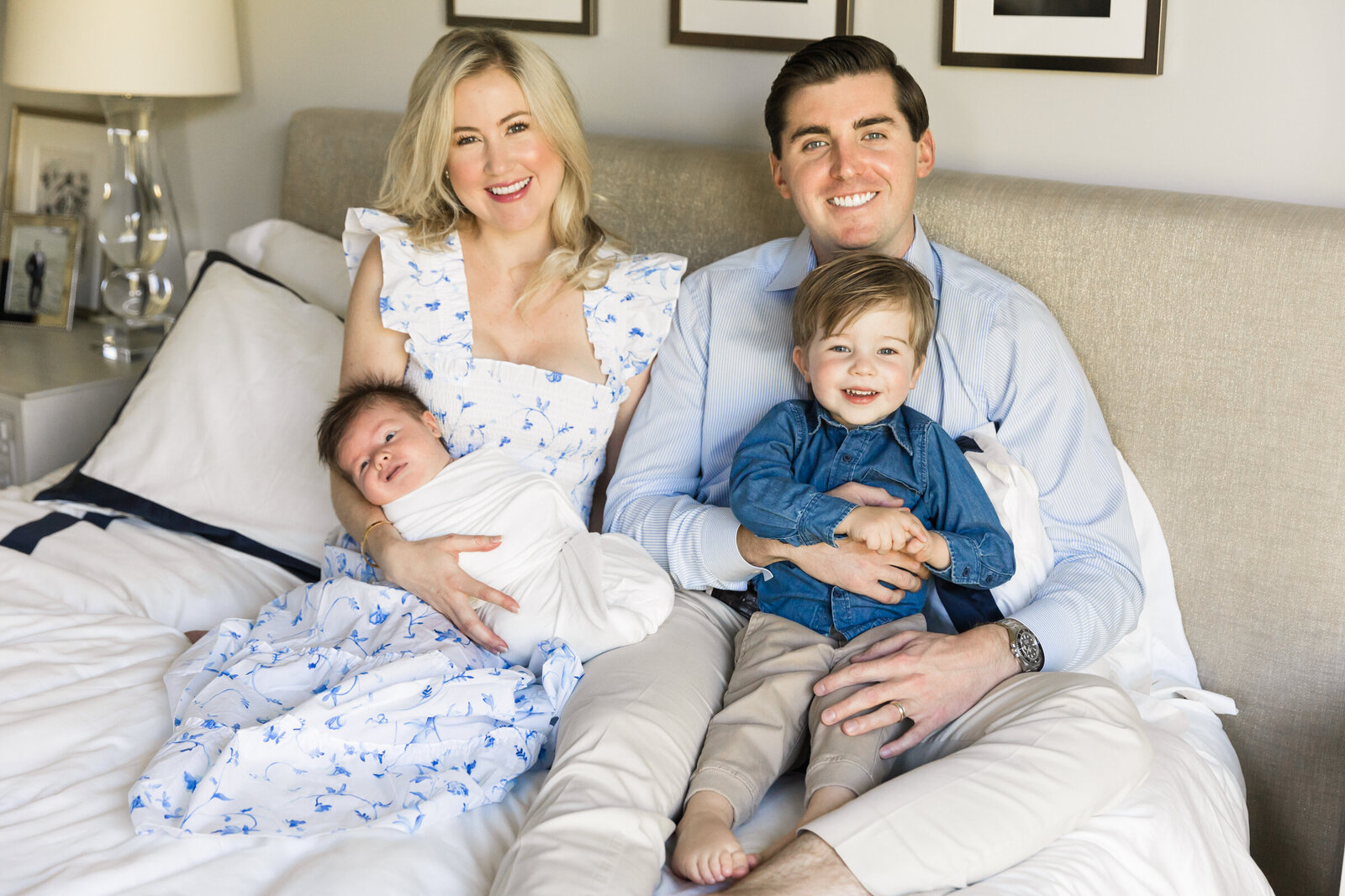 family smiling together in lifestyle session with newborn baby