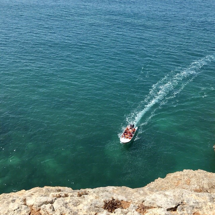 boat exploring the cliffs in the algarve