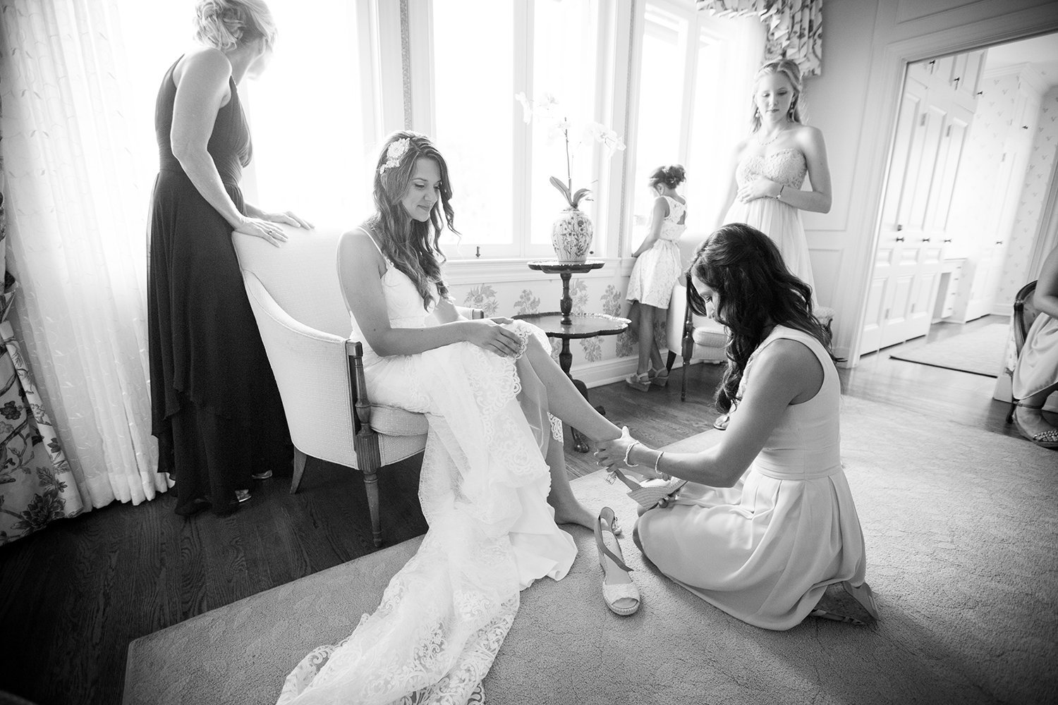 bride with lace dress at darlington house getting shoes on